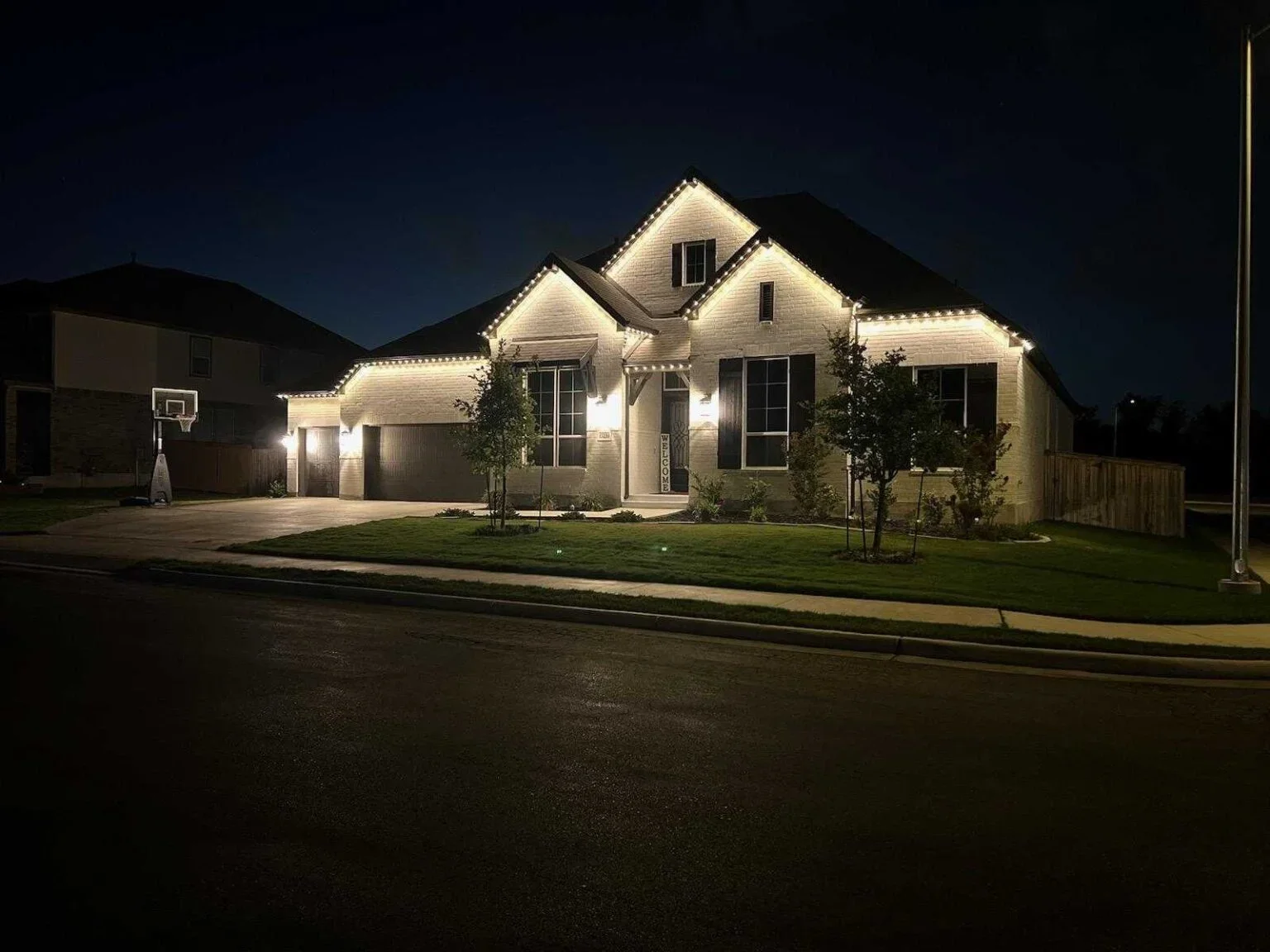 North Bismarck home with permanent lighting showcasing architectural features
