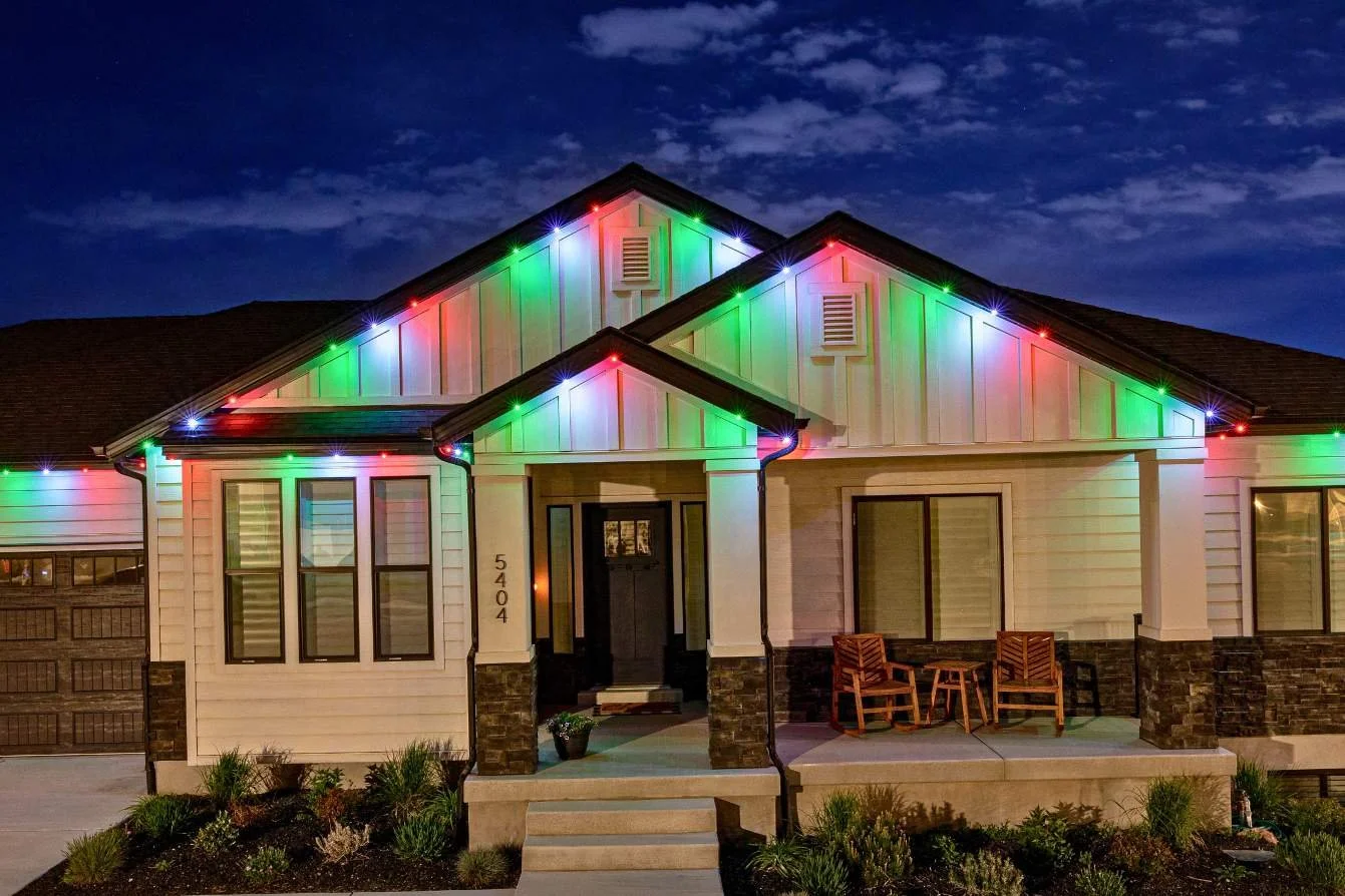 Elegant Mandan home with roofline and garden permanent LED lighting