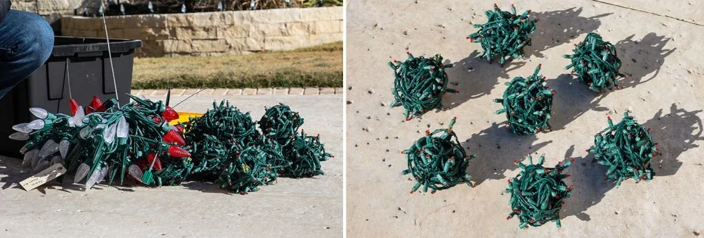 Disassembled Christmas string lights on wet pavement, in one pile and arranged in spheres with shadows.