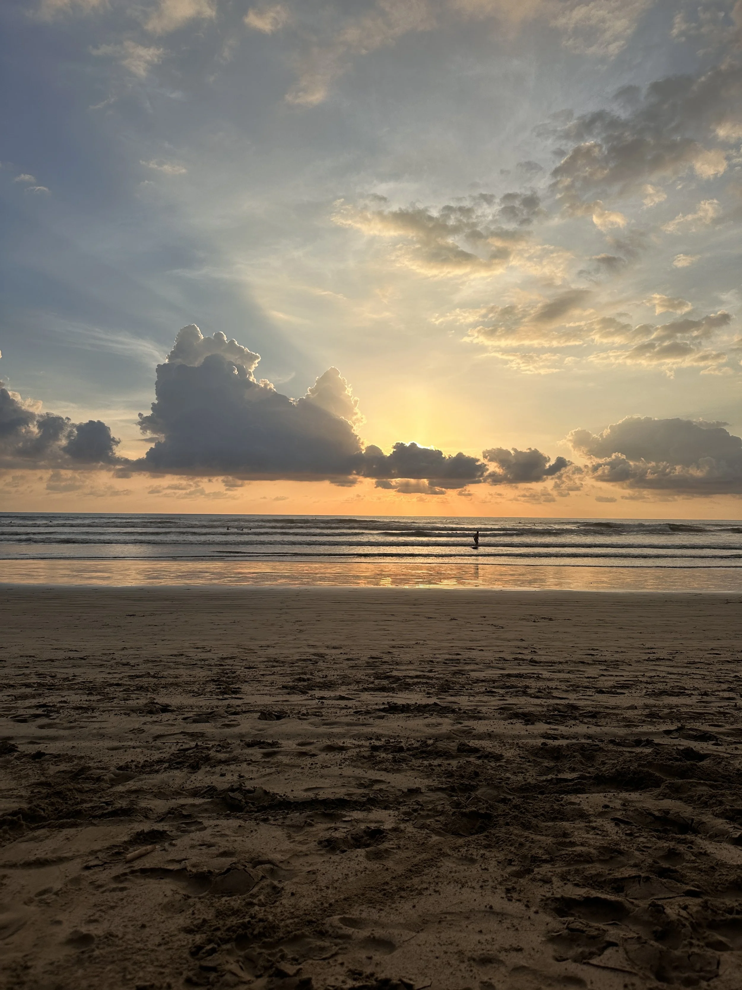 Sun behind clouds over beach, Costa Rica