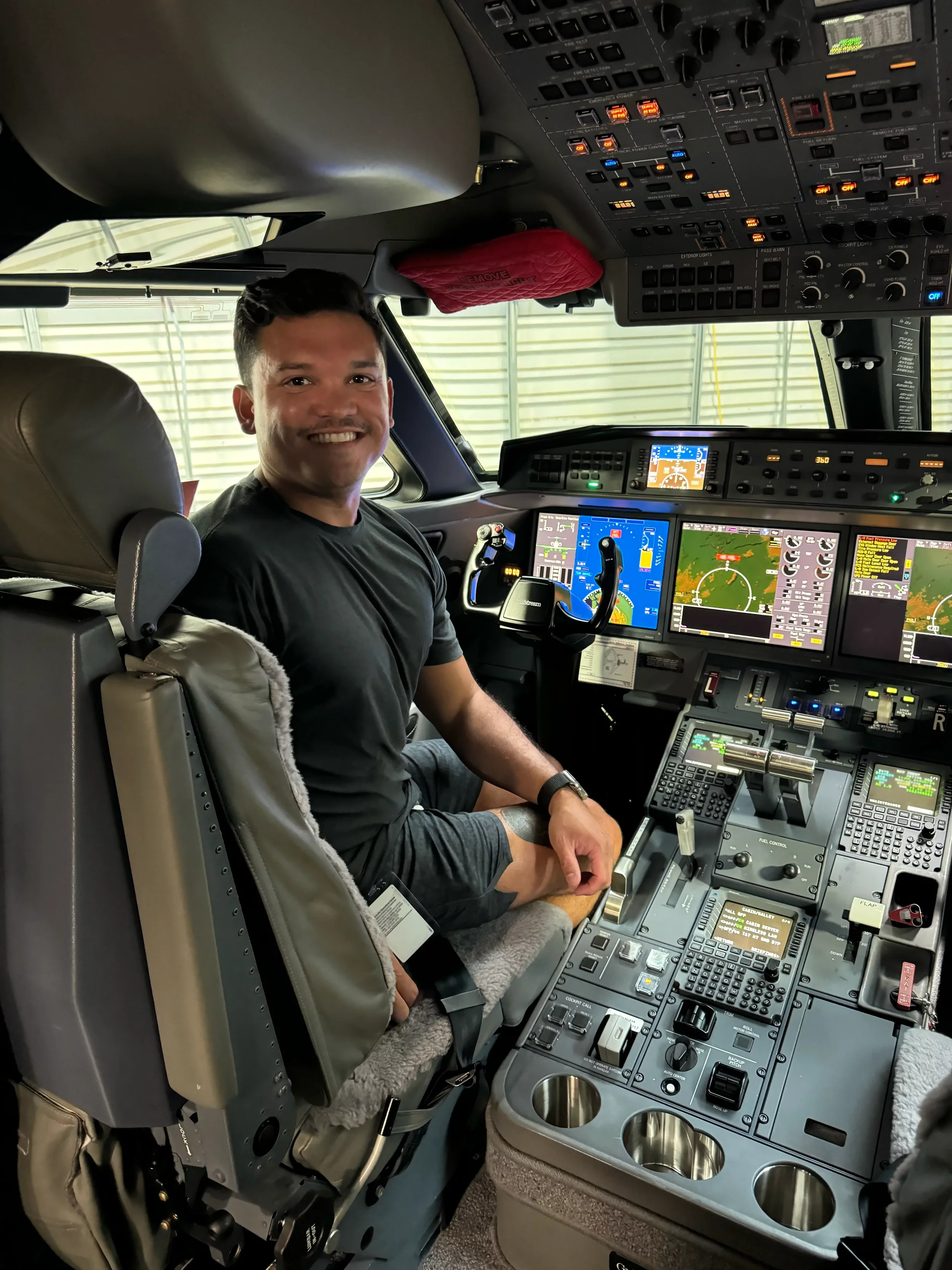Rich Clum sitting in the Adobe Gulfstream G650ER corporate jet cockpit