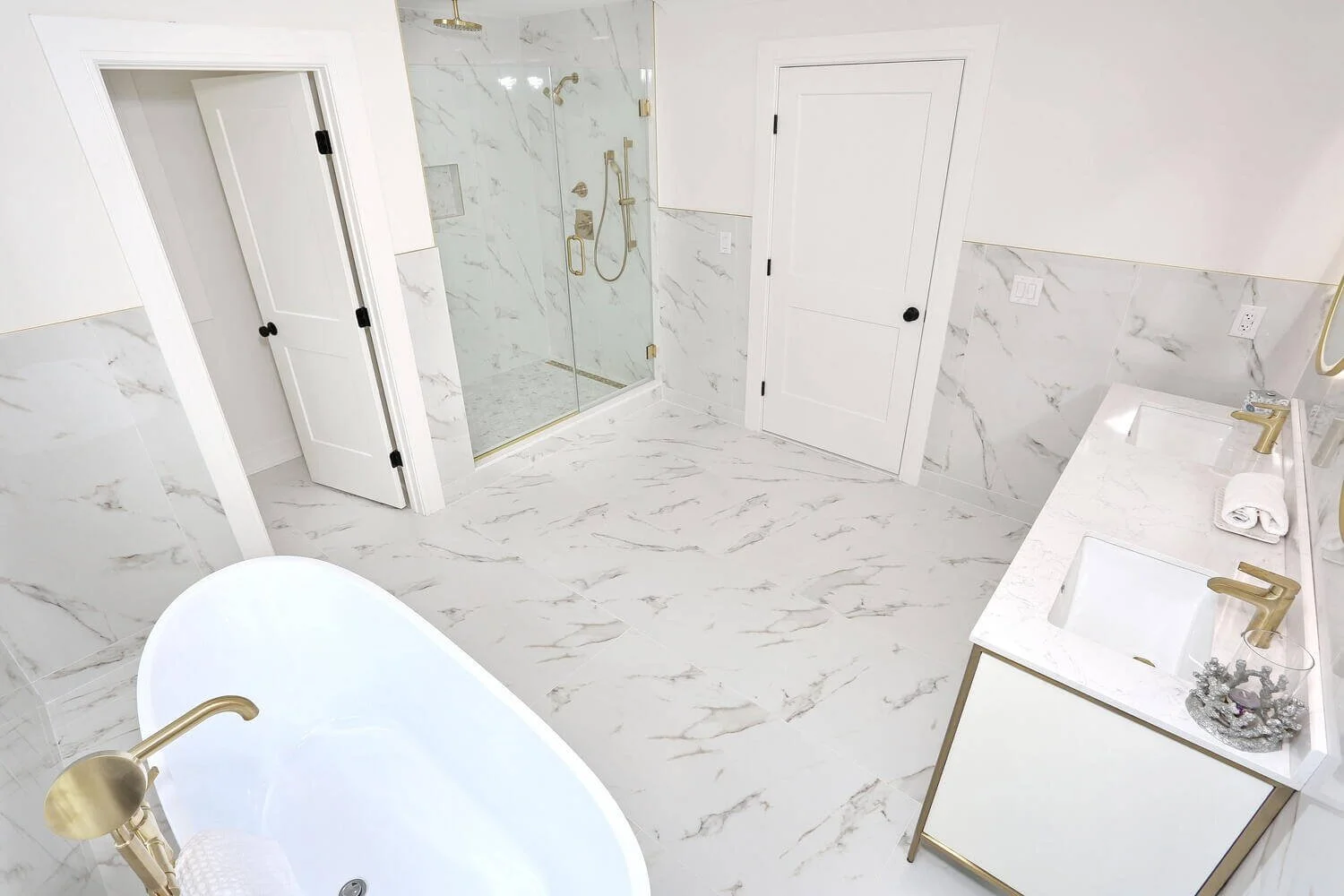 Overhead view of primary bathroom layout showing glass shower, freestanding tub, and double vanity in a Park Ridge modern farmhouse by Dadak LLC.
