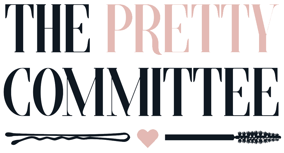 Text reading 'The Pretty Committee' with decorative broomstick, heart, and wand icons.