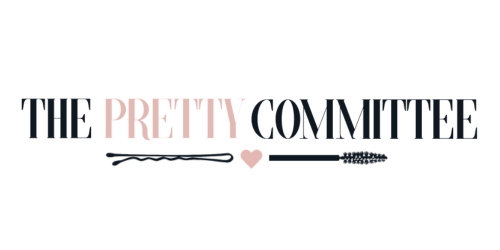 Text logo that reads "THE PRETTY COMMITTEE" with a small heart and decorative arrow underneath.