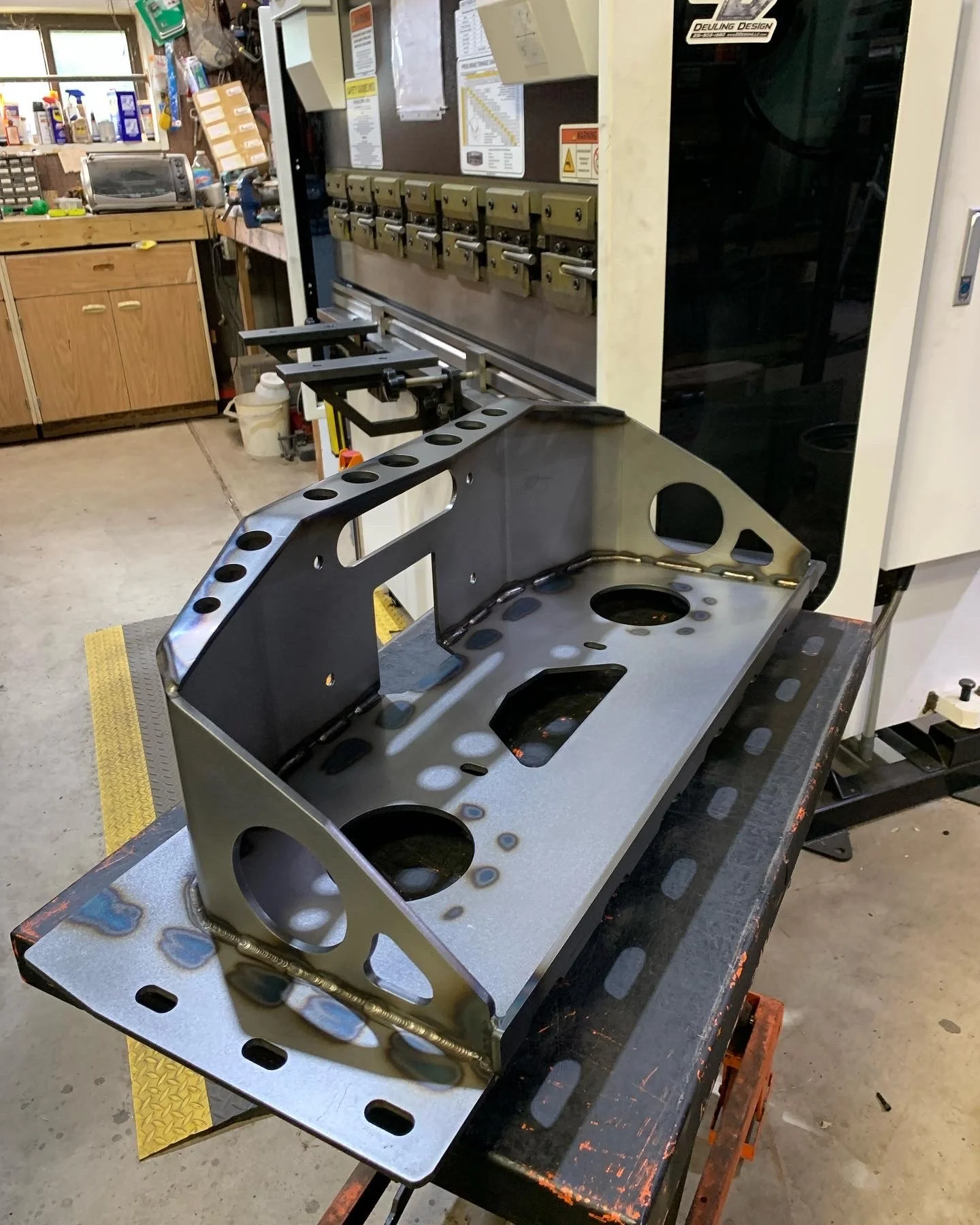 1/4-inch A36 steel component showing precision fabrication and weld seams in a workshop.