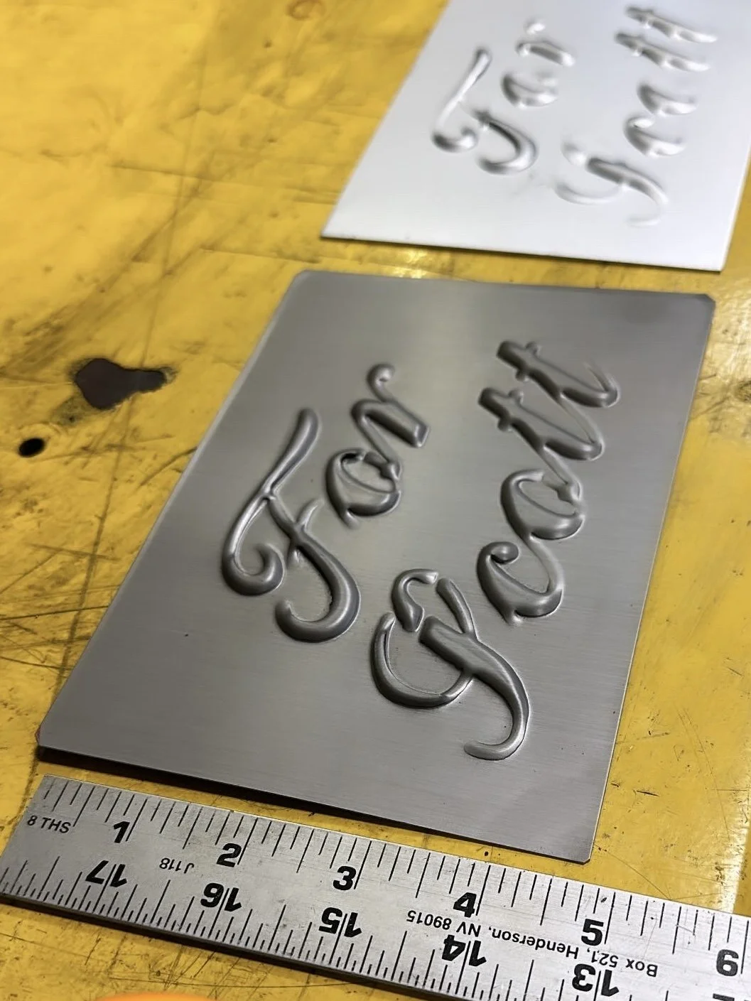 Small batch stamped metal with the verbiage "For Scott" in script and ruler to the side.