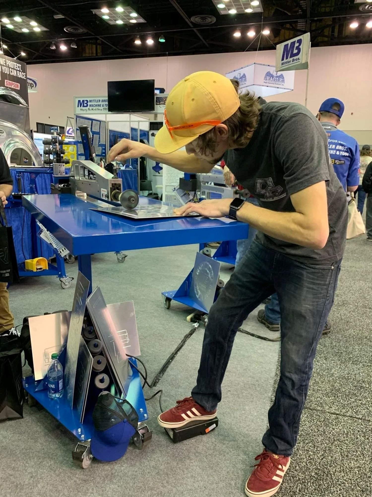 Adam Deuling demonstrating bead rolling on a sheet metal panel at PRI trade show.
