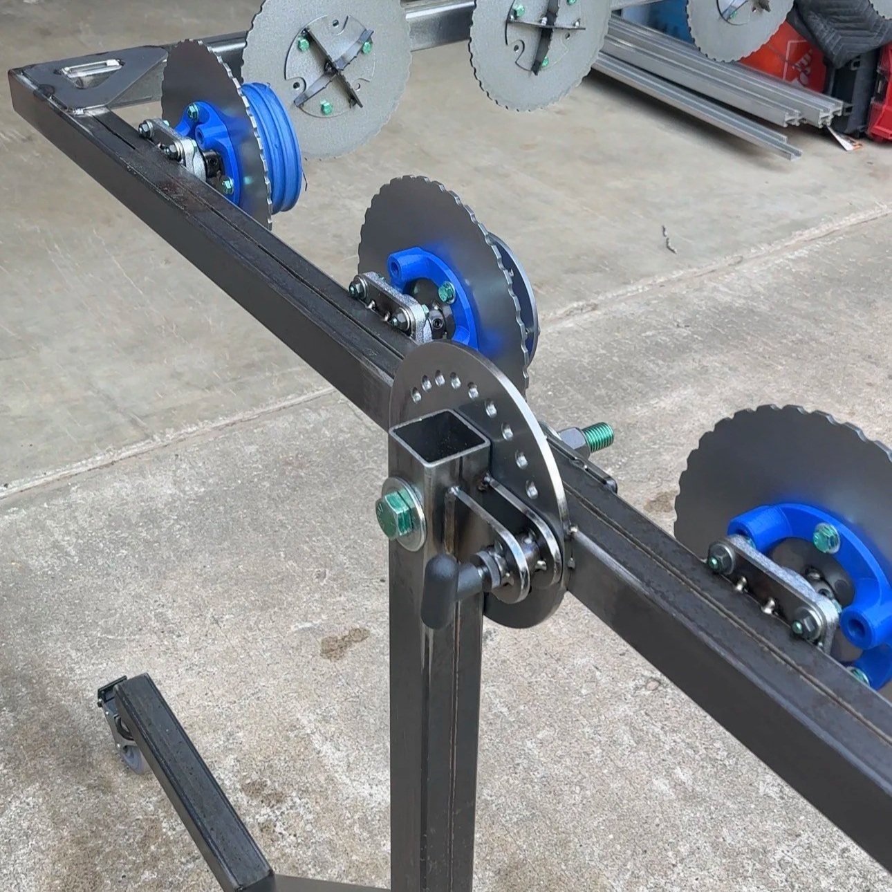 Custom metal painting rack with 3d printed blue spring holders and circular metal components.