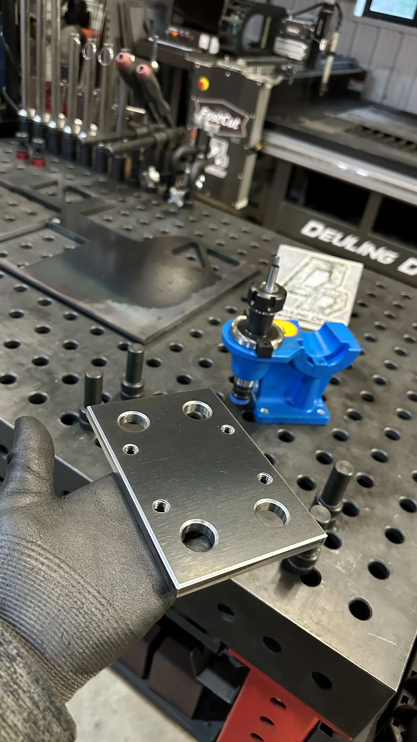 Custom CNC-machined metal component with precision-drilled mounting features.