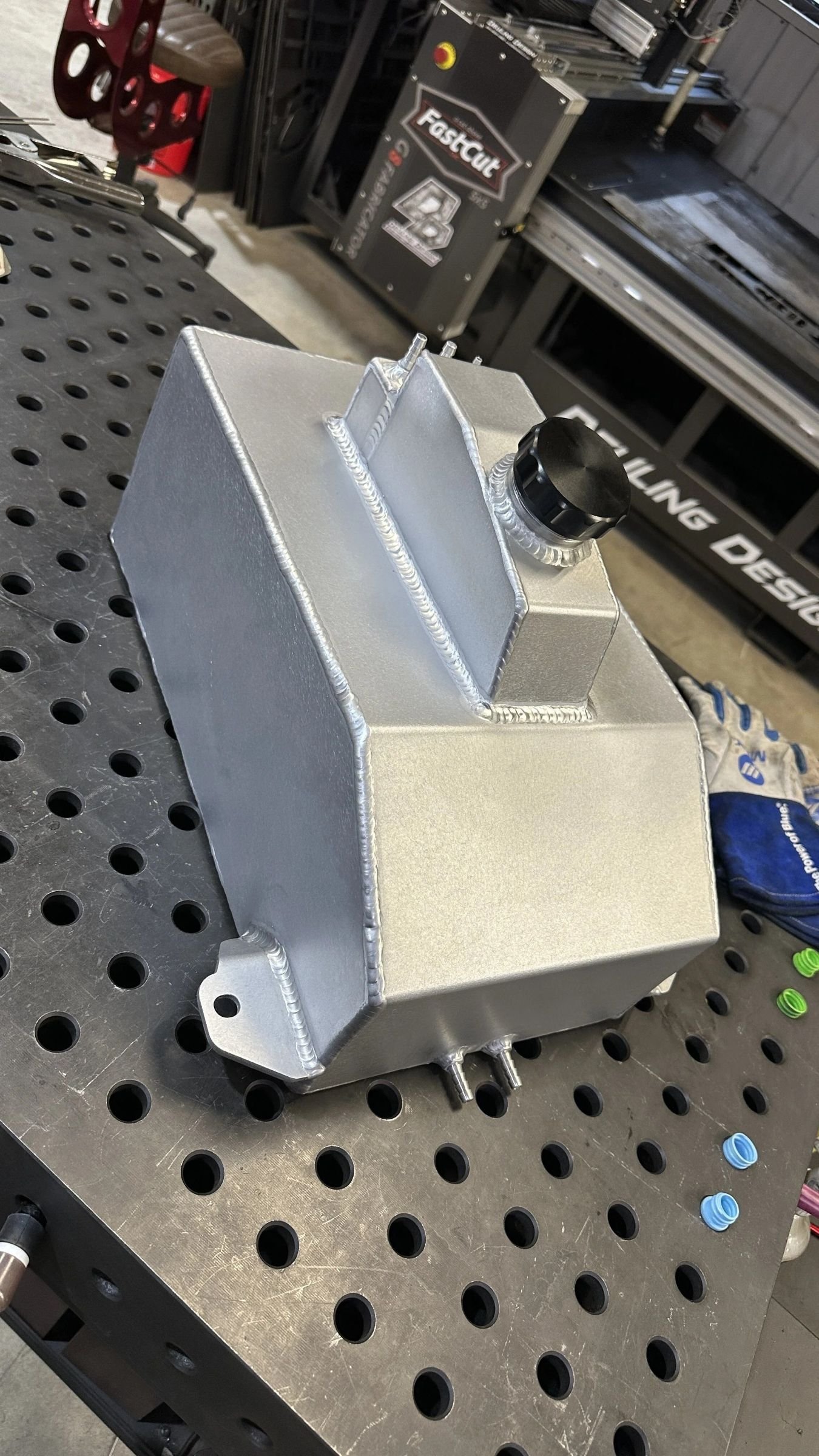 Custom aluminum tank fabrication with precision welds and a threaded filler neck.