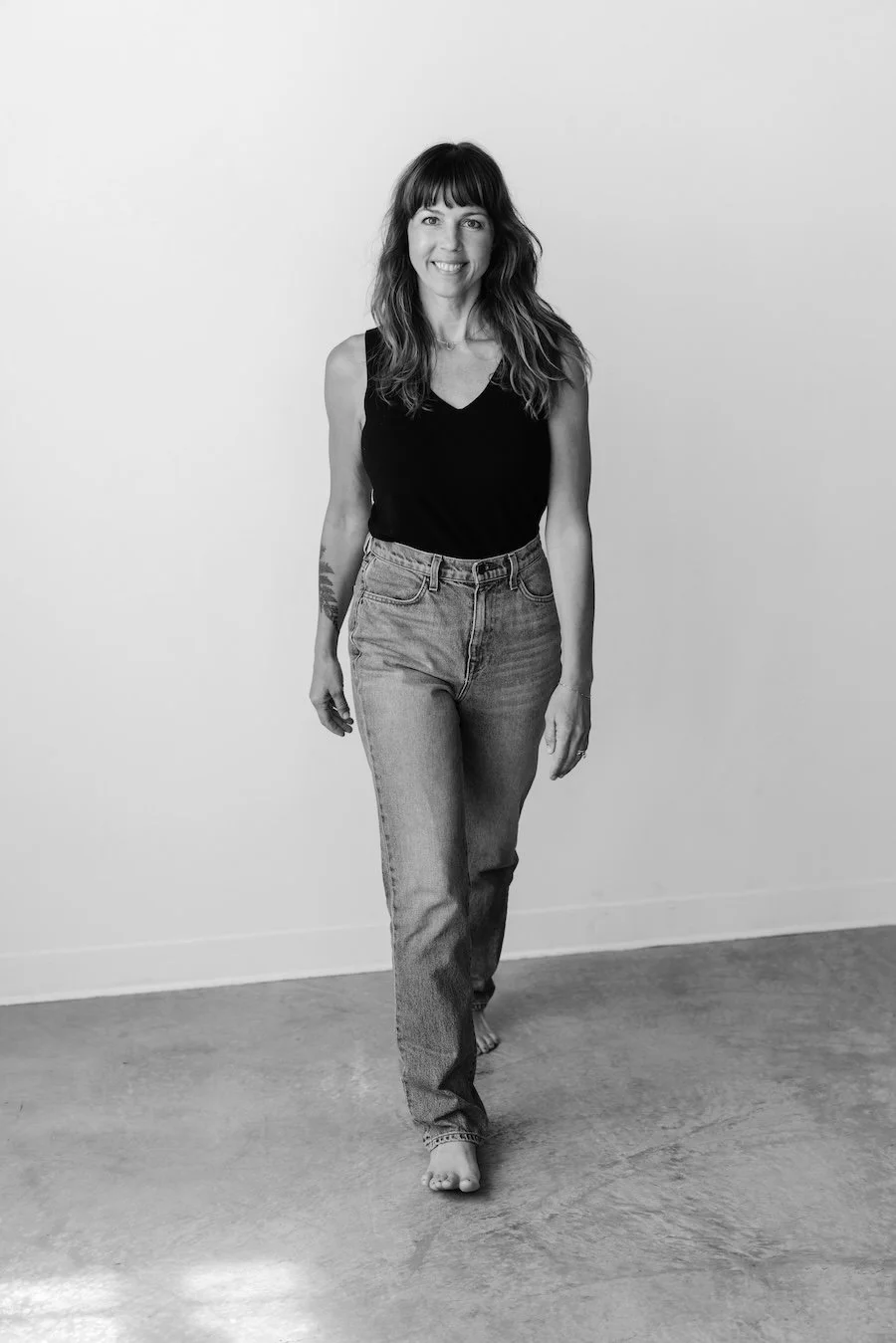 woman artist Jodi Kendall walking towards camera in black-and-white color