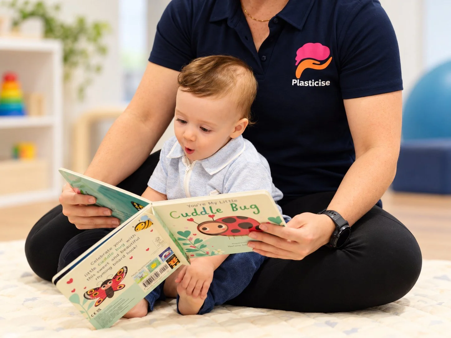 Therapist reading a picture book with a toddler