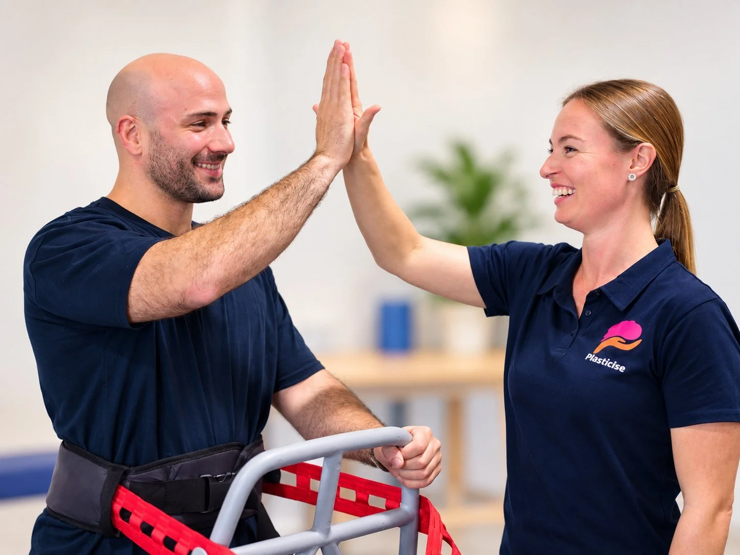 Physiotherapist high-fiving a client during walking practice