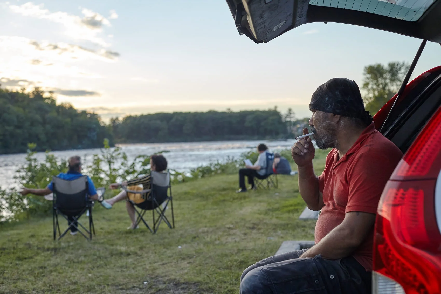 man-smoking-car-people-sitting-river-forest-view-prospect.jpg