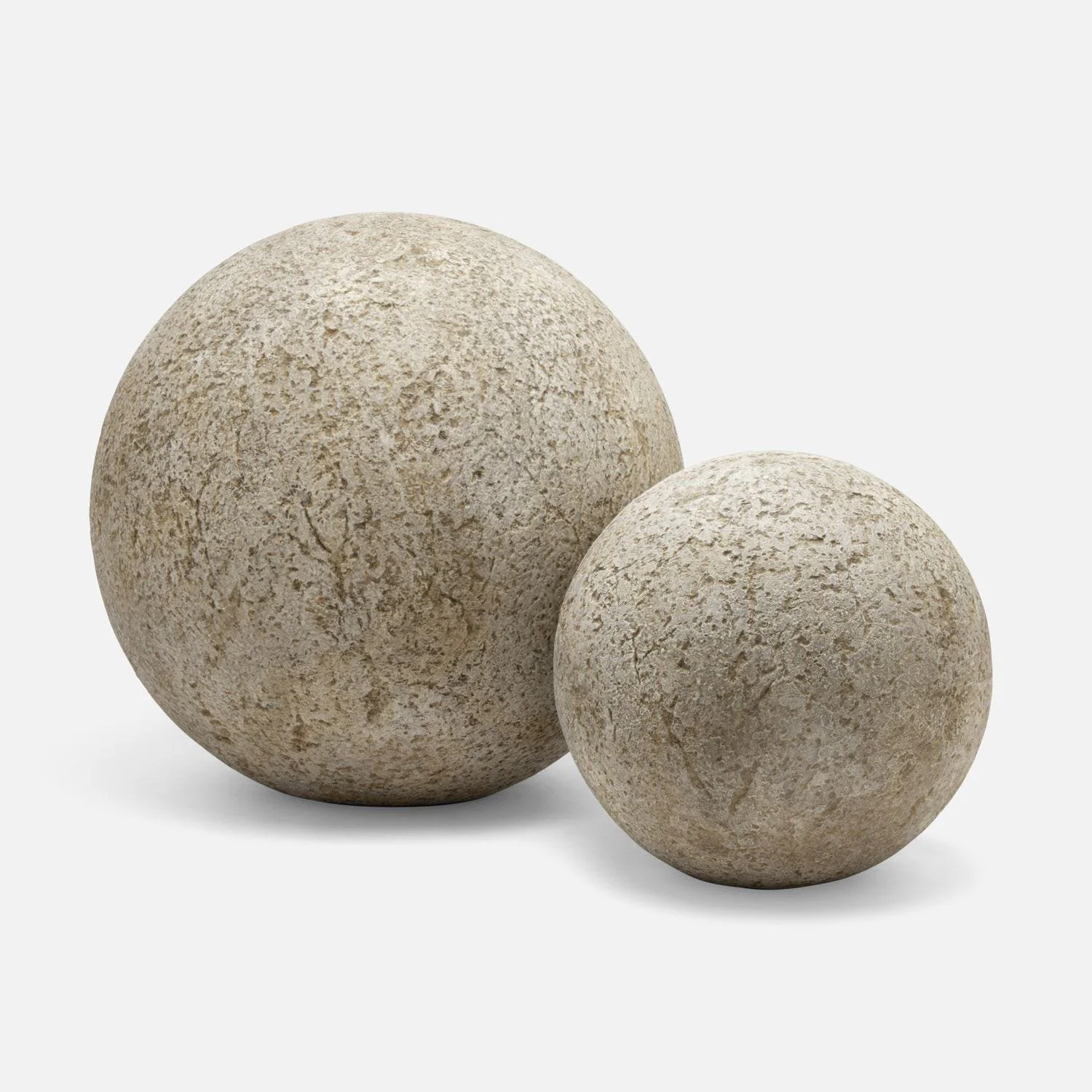 Two textured beige stone spheres, one larger and one smaller, on a white background representing a couple.
