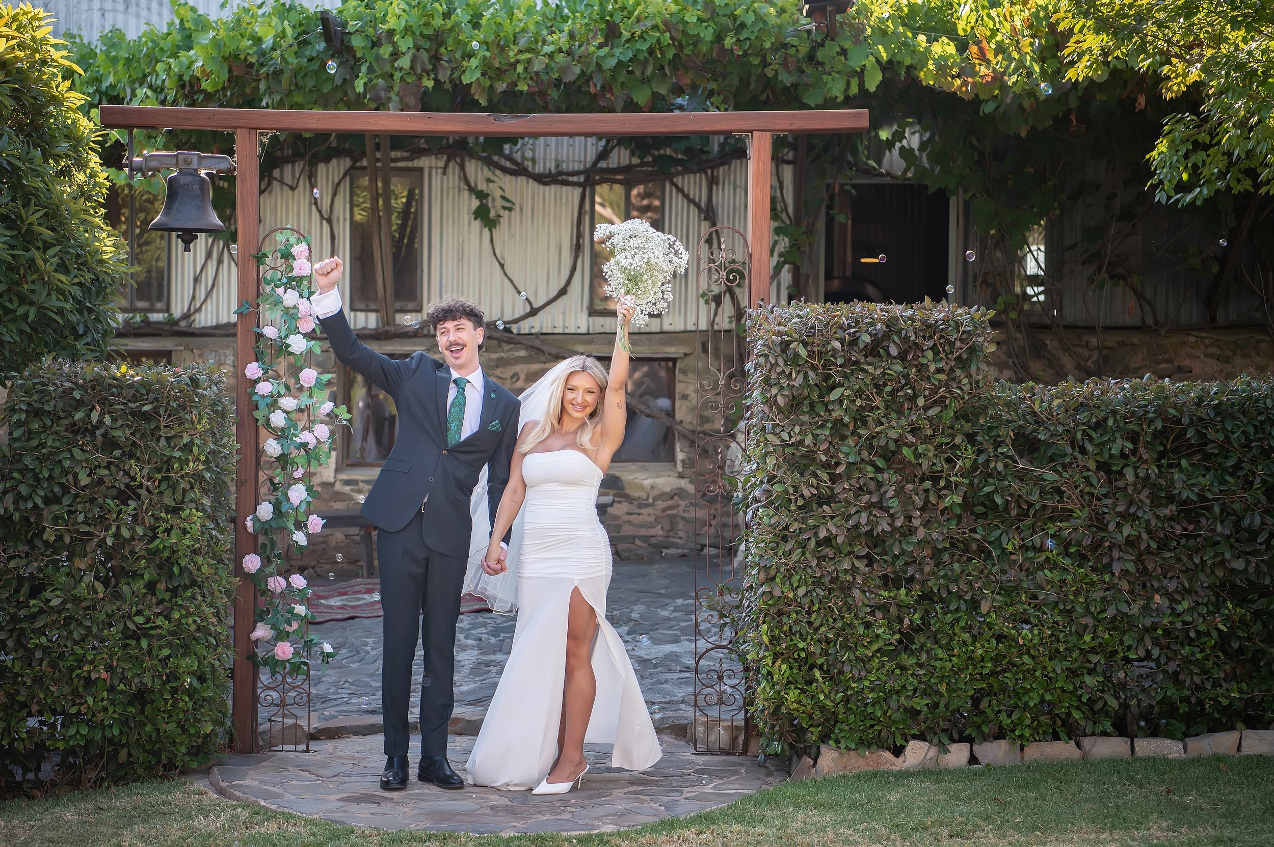 The happy couple under the arbor