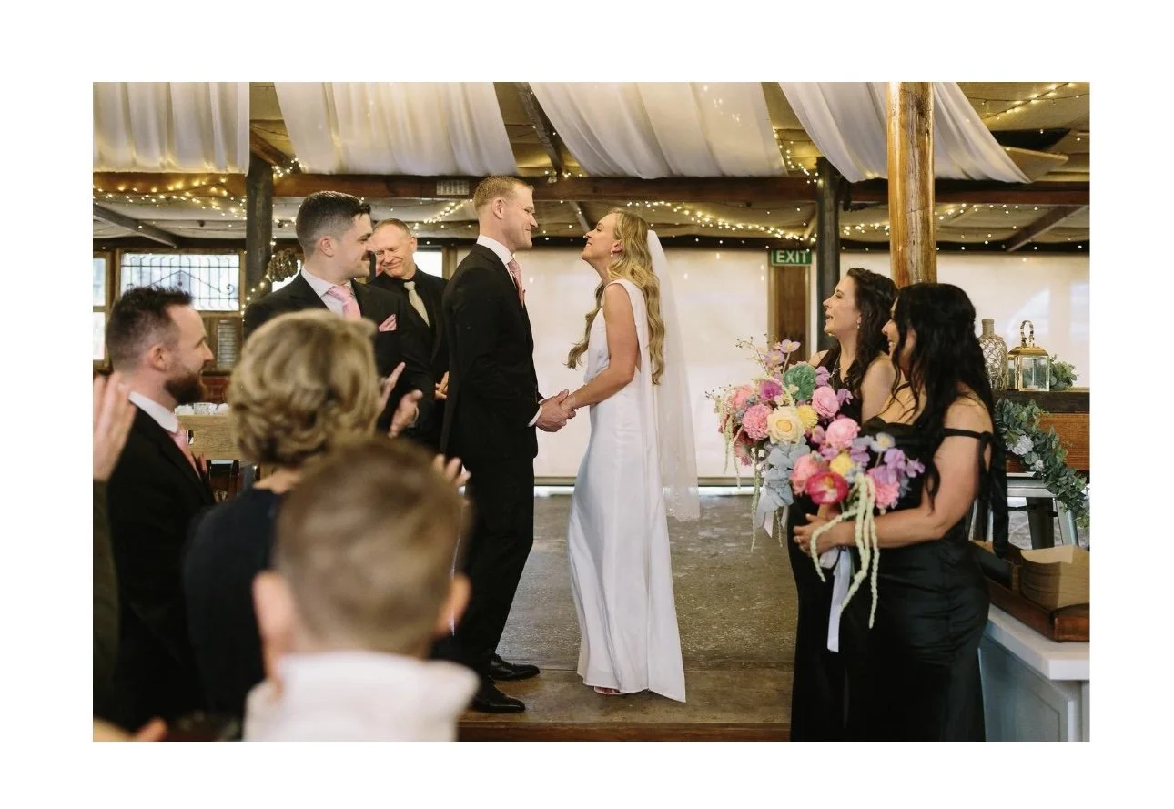 Bride and groom inside the restored barn after the rain came