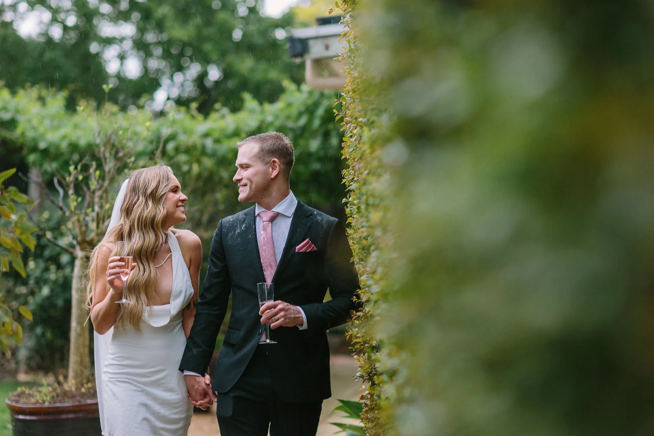 stunning married couple walking through the gardens at Morning Star