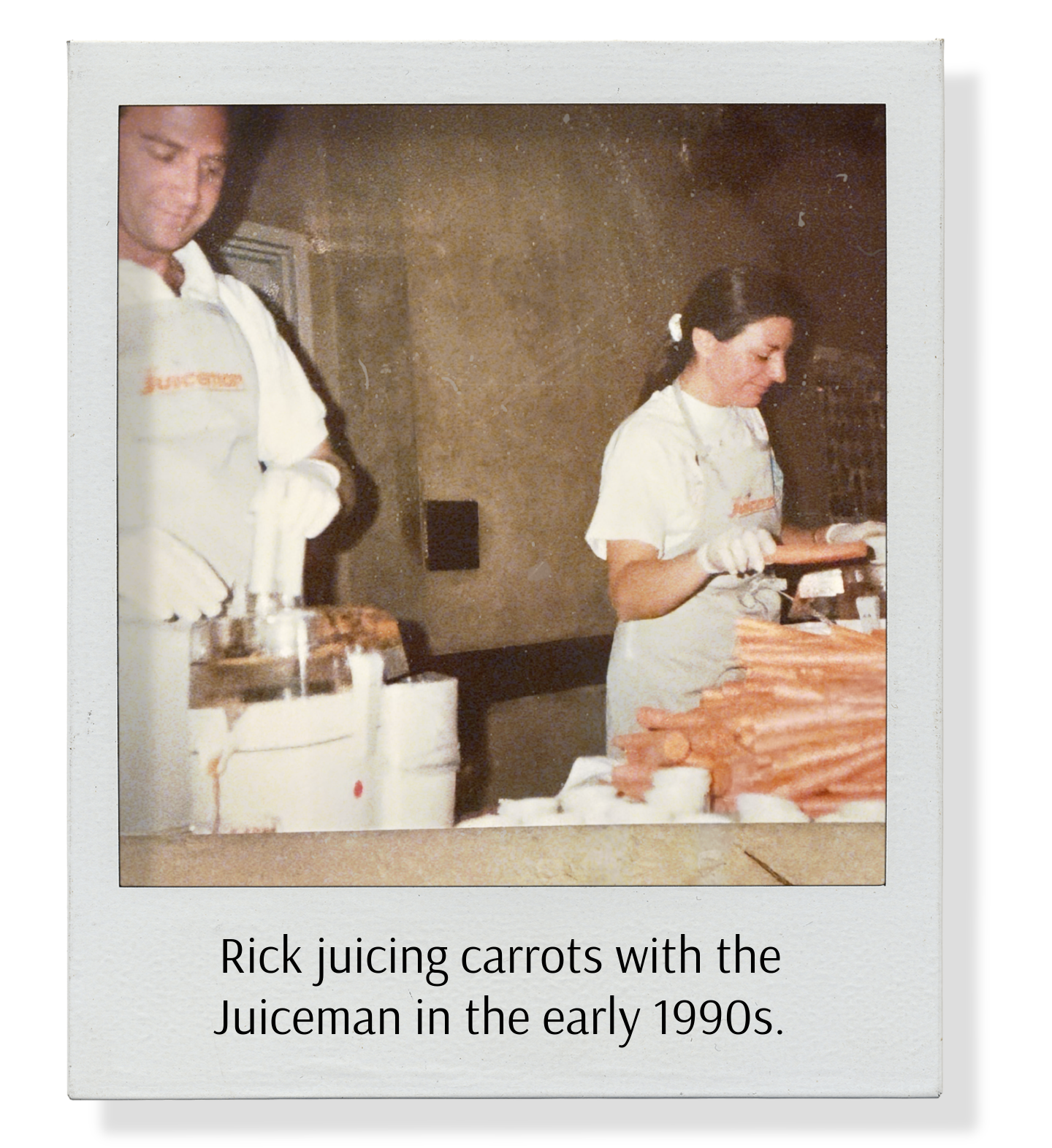 Photograph of Rick juicing carrots with a juicer while a woman looks at the carrots, taken in the early 1990s.