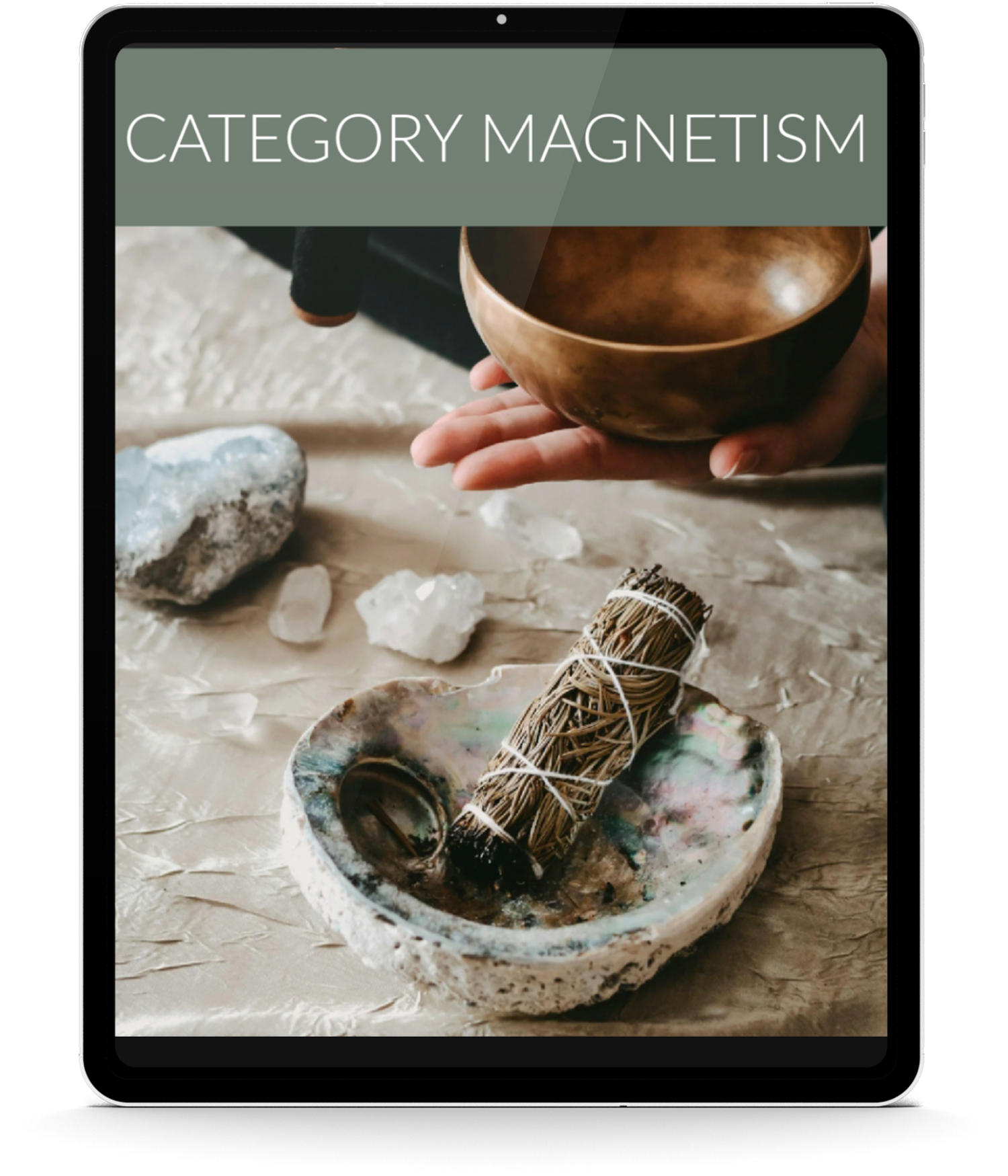 A person holding a singing bowl, with crystals, a bundle of herbs, and other spiritual items on a table.