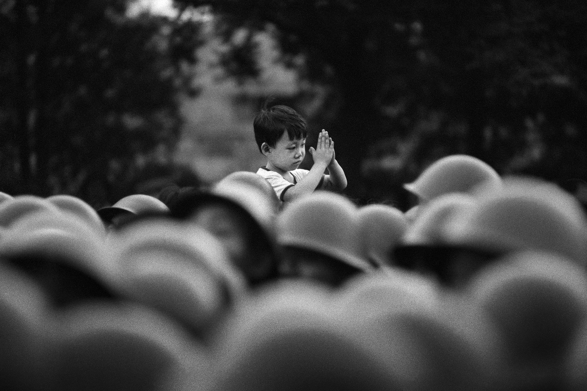 Dario Mitidieri, Beijing, 1989. A boy greets soldiers approaching Tiananmen Square in Beijing, just hours before the crackdown. Silver Gelatin Print on baryta paper. Limited edition. Various sizes.