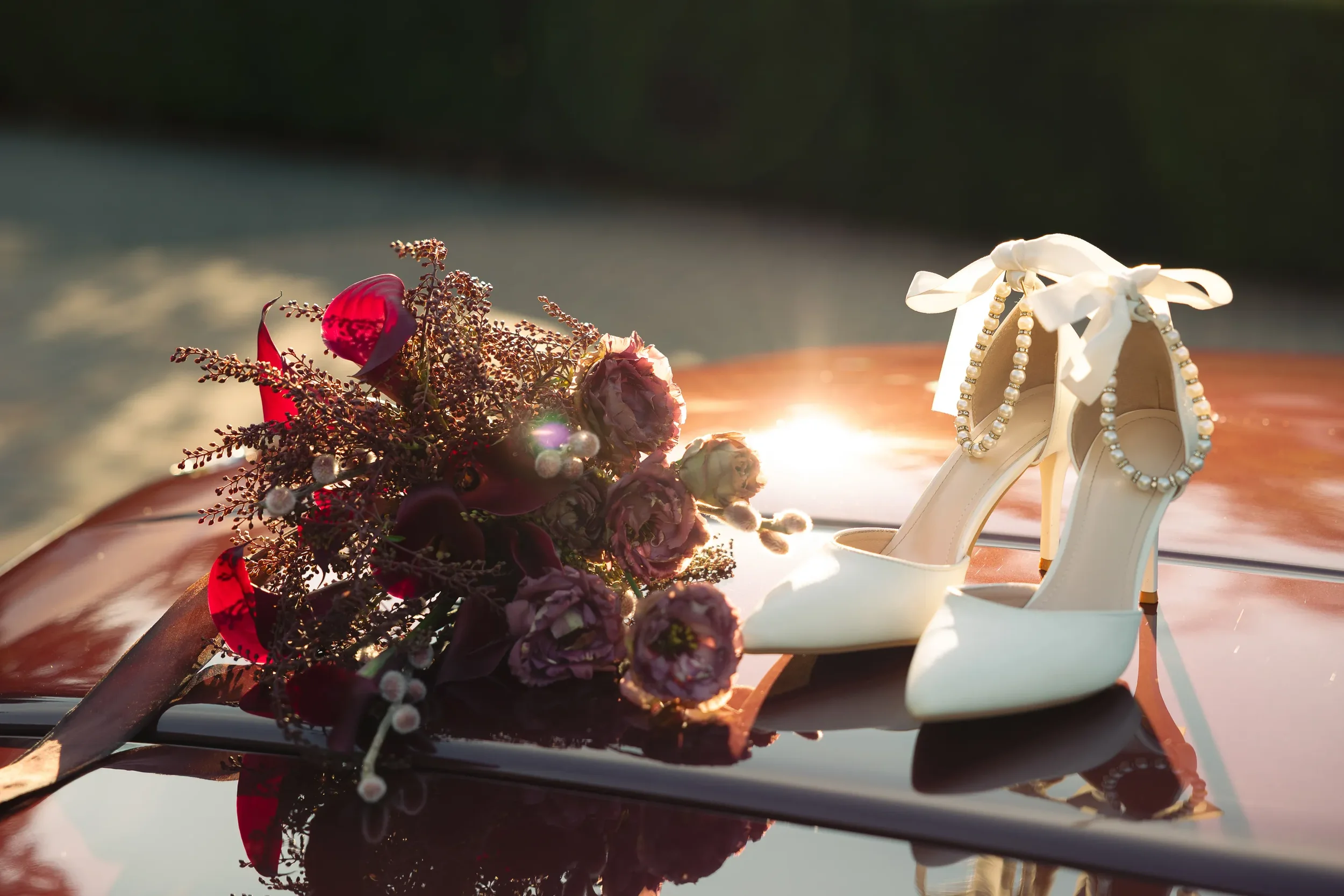 Burgundy wedding bouquet with calla lilies and pearl strap bridal heels on vintage Mercedes at Fox Hollow Farm luxury wedding by Seattle wedding photographer