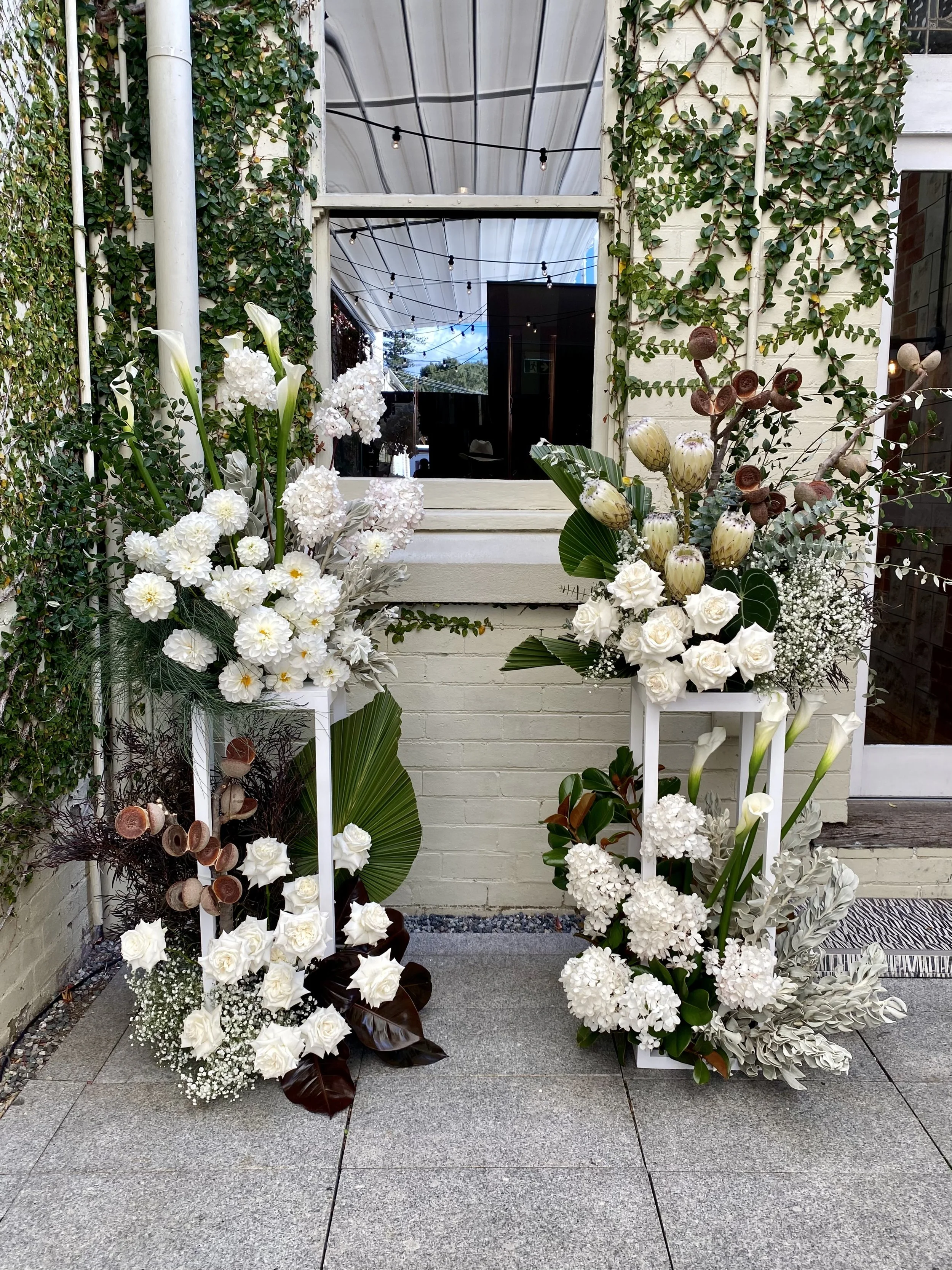 White modern grouped ceremony plinth flowers.jpg