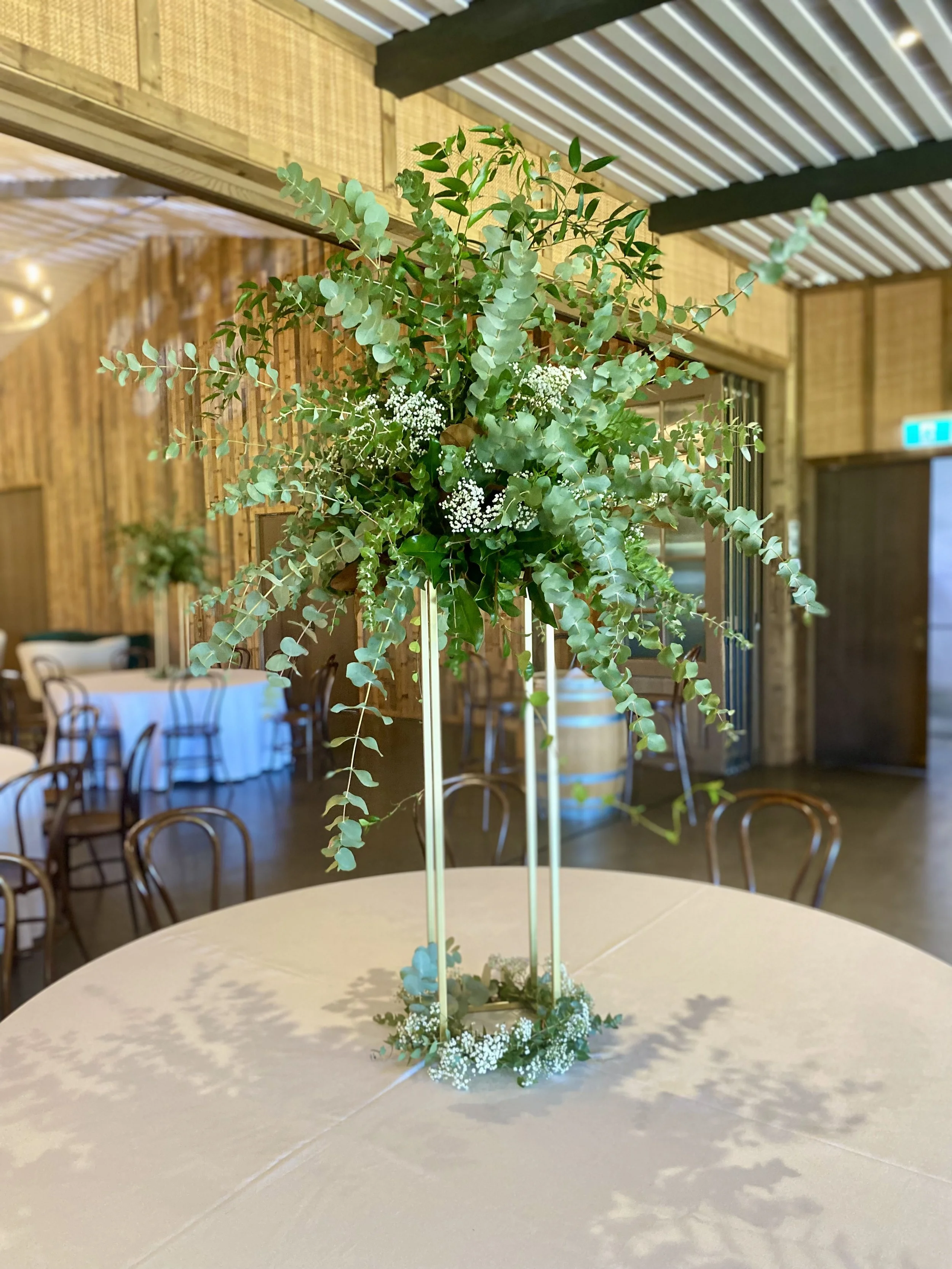 Eucalyptus and greeenry tall riser recption table arrangement.jpg