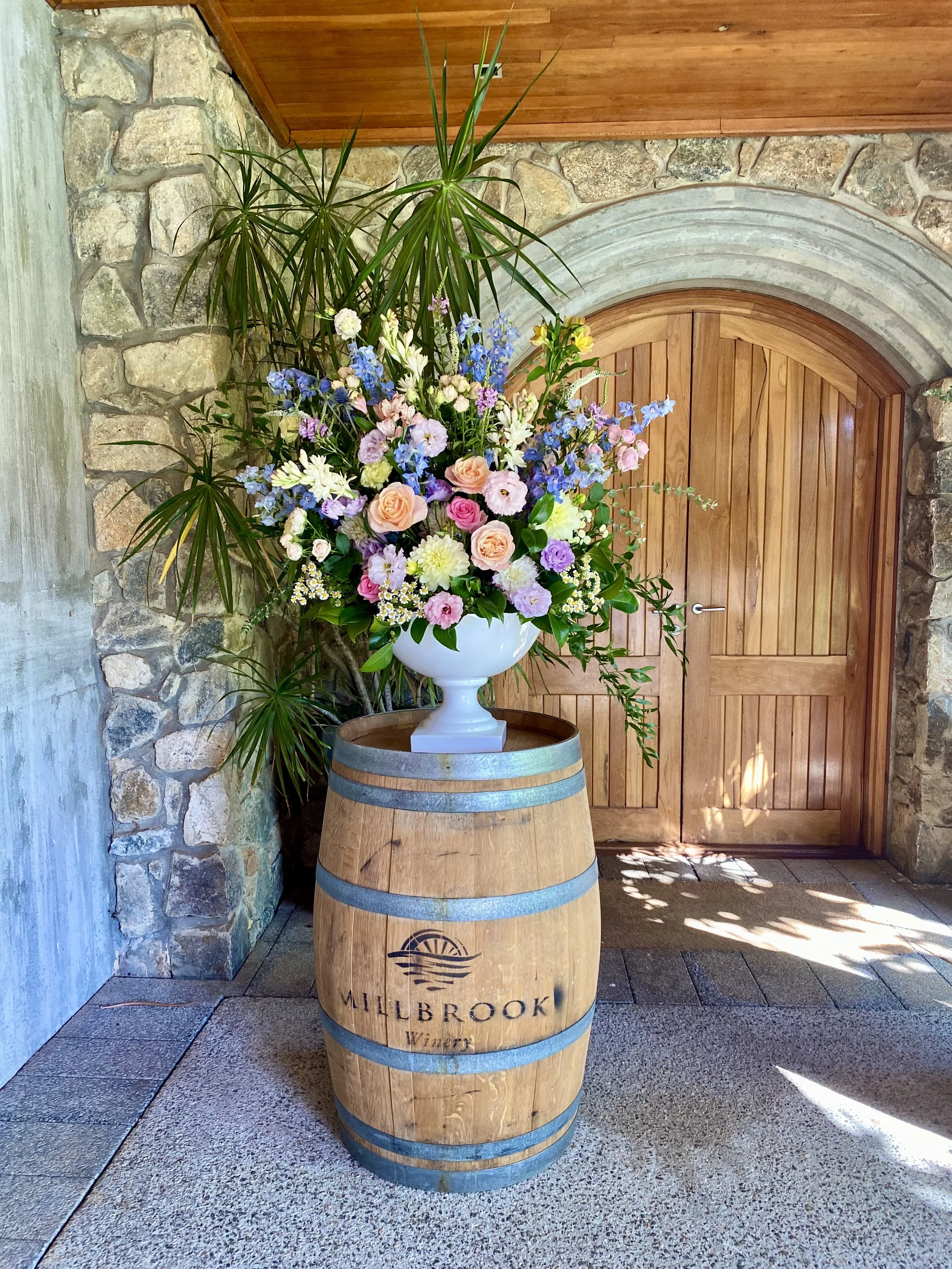 Pastel coloured ceremony urn on wine barrel.jpg