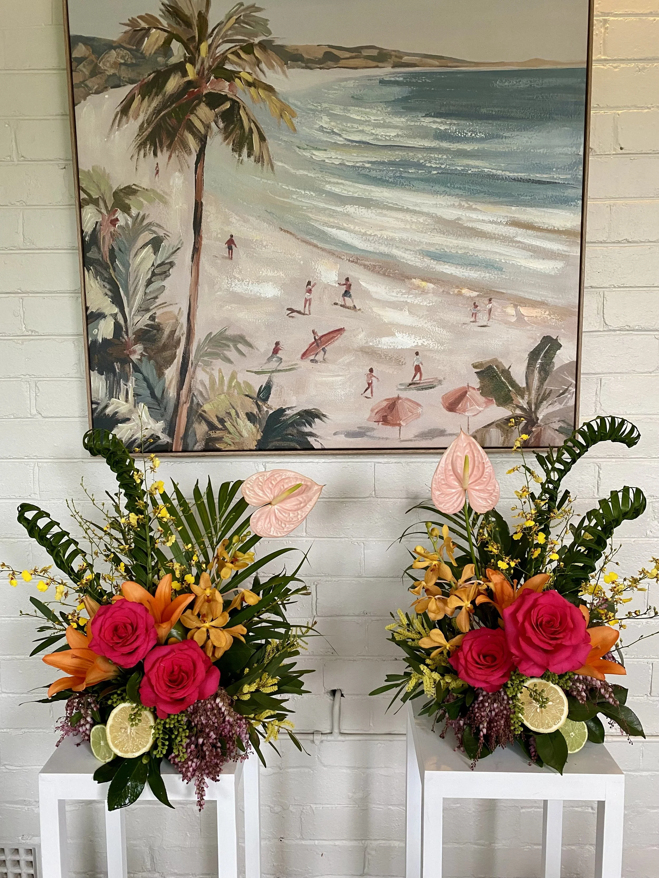 Matching tropical bar florals with hot pink roses, orange lilies, yellow orchids and citrus. Penny Dormer, Wild Heart Flowers — corporate event florist Perth.