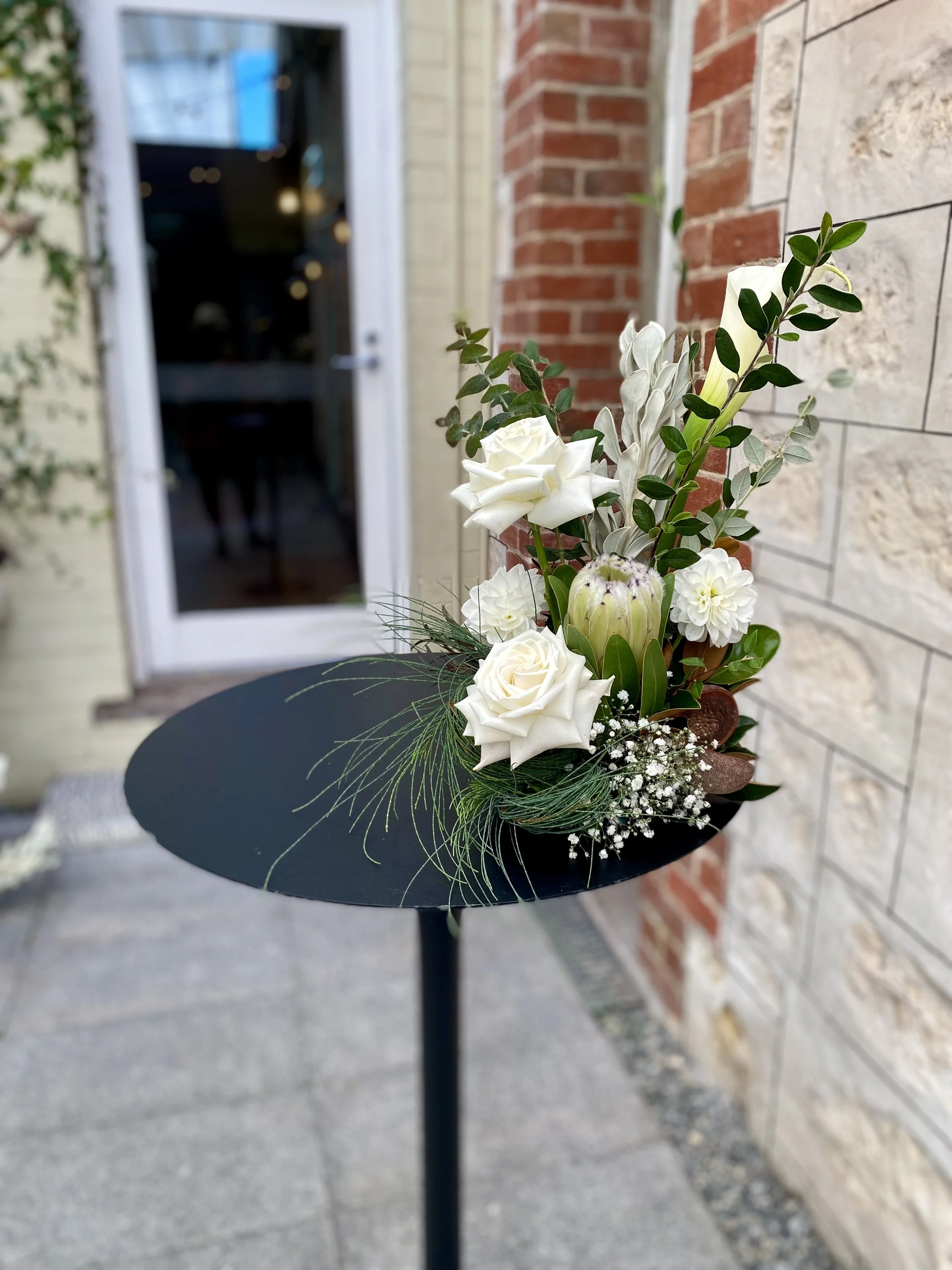 Ceremony signing bar table wjite flowers.jpg