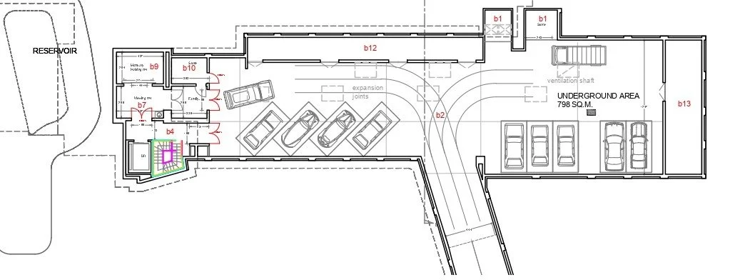 Architectural floor plan of an underground parking garage and associated building area, showing parking spots, vehicle lanes, and various labeled sections.