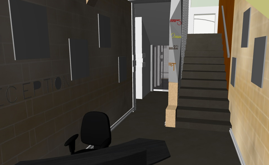 Interior of a modern building with stairs, walls decorated with picture frames, and a reception area with a black office chair and a desk.