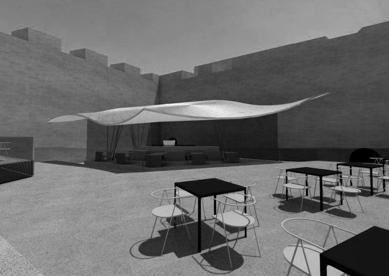 An outdoor seating area with several tables and chairs, a large fabric canopy providing shade, and a concrete wall surrounding the space.