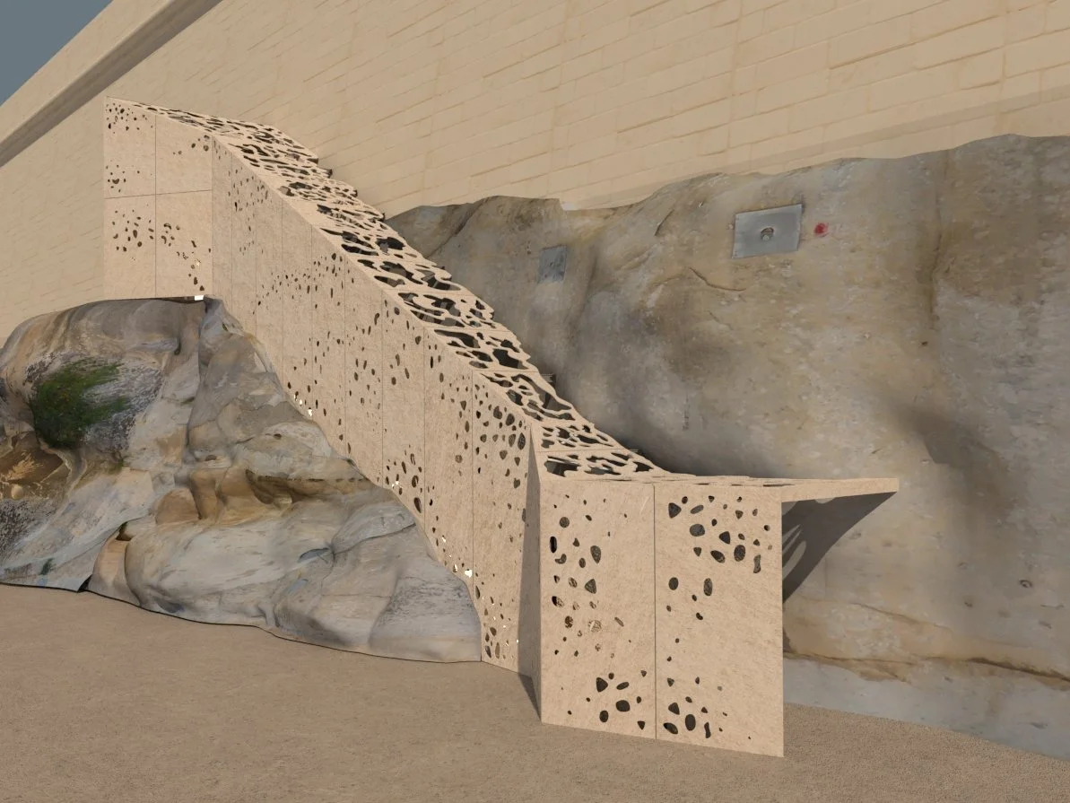 A modern staircase with perforated sides, set against a natural rock wall inside a building.