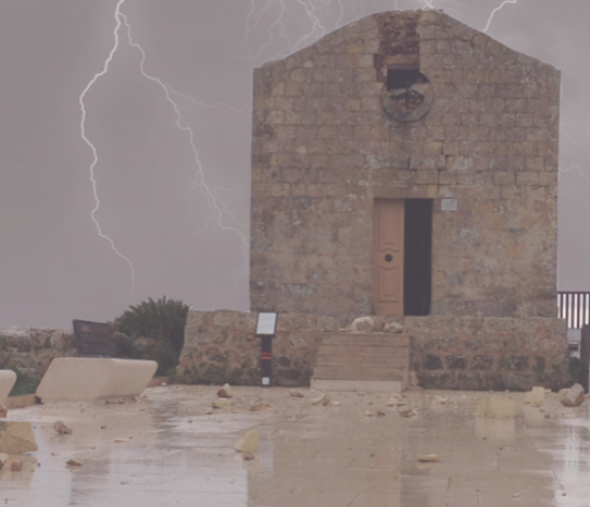 A small stone building with a wooden door, set against a stormy sky with lightning, and a flooded area in the foreground.