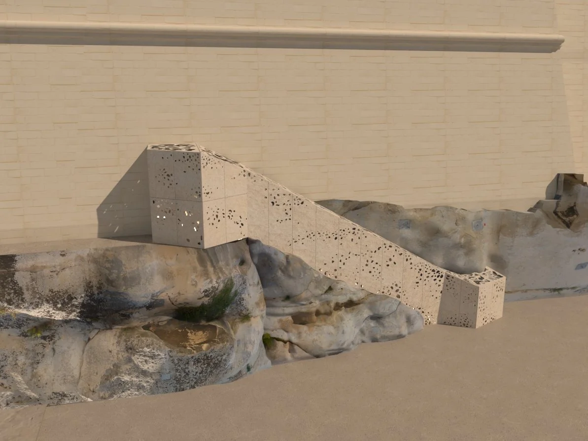 Sculpture combining concrete blocks with perforations and natural rocks, set against a beige brick wall.