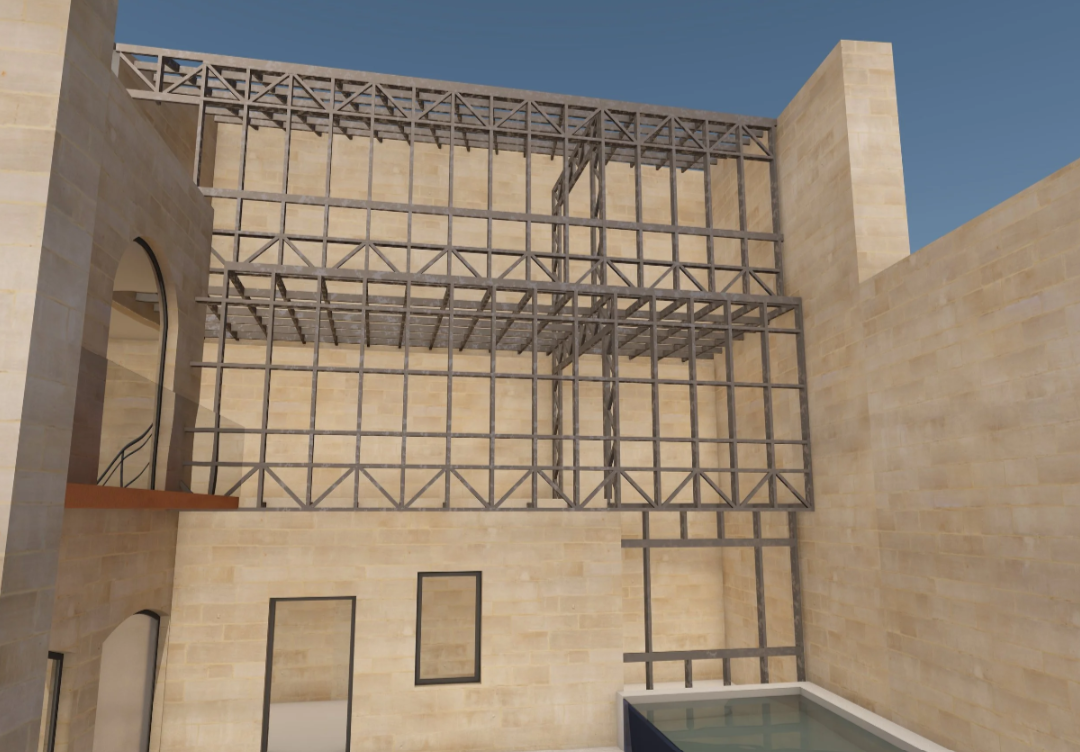Building under construction with a metal framework against beige stone walls and a swimming pool in the foreground, under a blue sky.