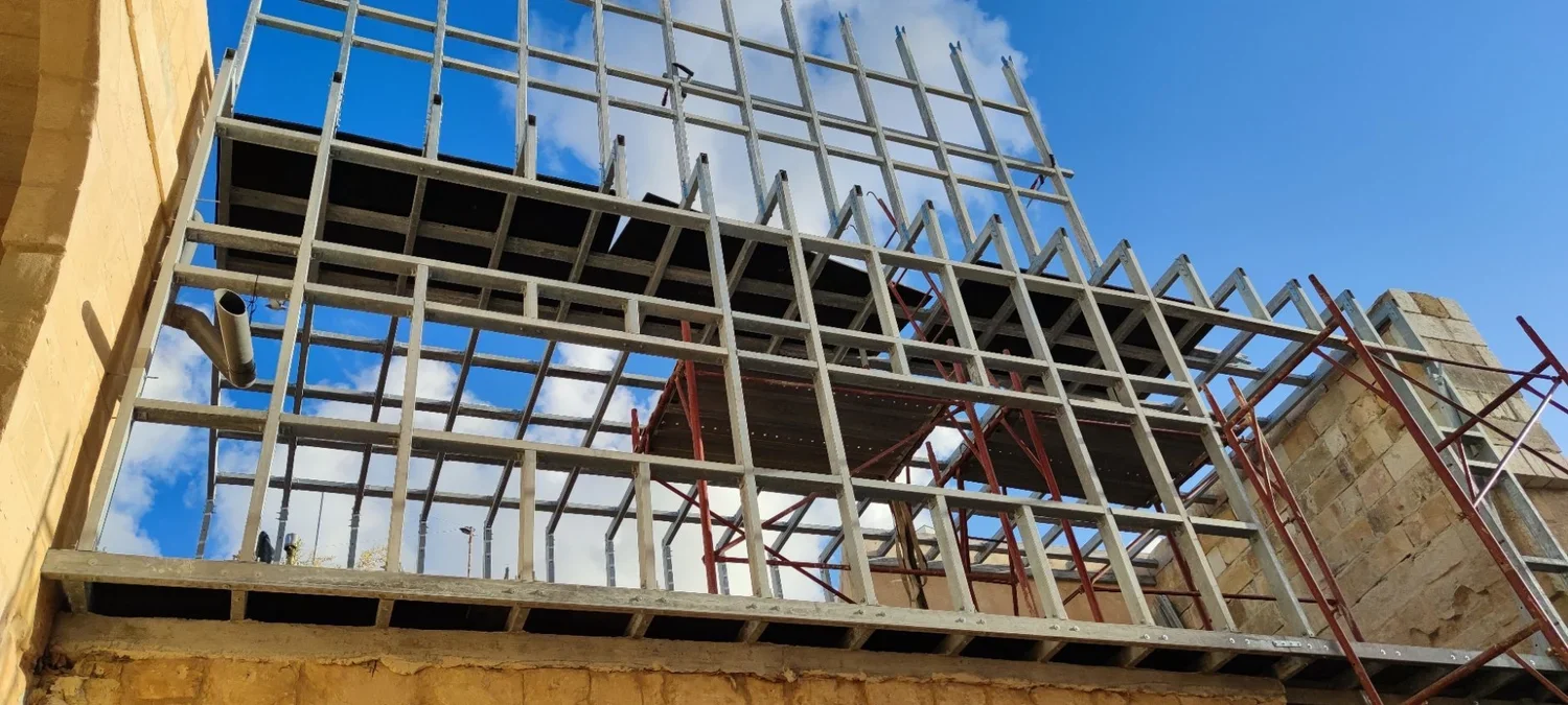 Construction site with metal framework and scaffolding for building or renovation.