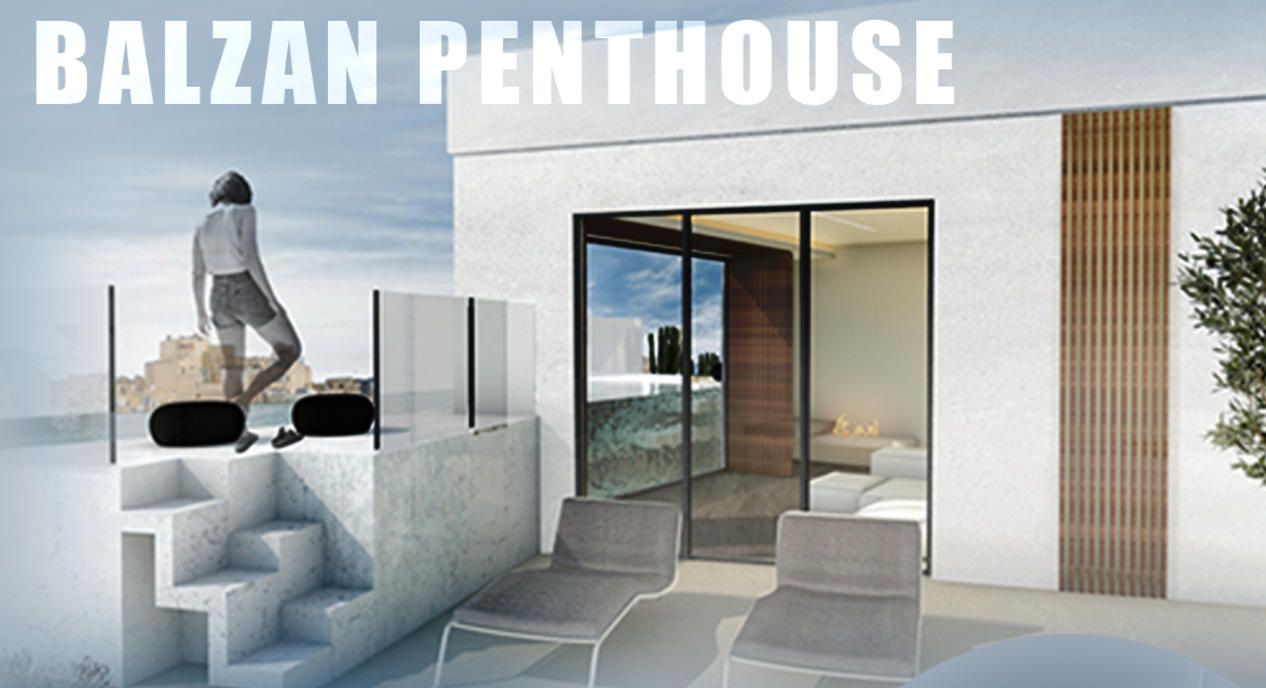 Exterior view of a modern penthouse named Balzan Penthouse with a small outdoor terrace, two lounge chairs, a glass railing, and a woman standing on the terrace overlooking a city skyline and sky.