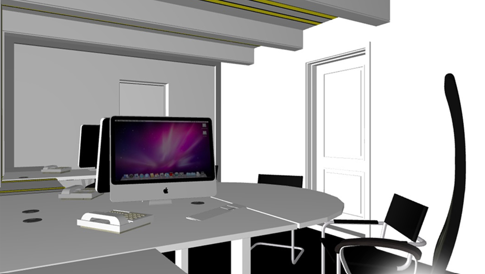 An office meeting room with a large round table, an iMac computer, black chairs, and a white door.