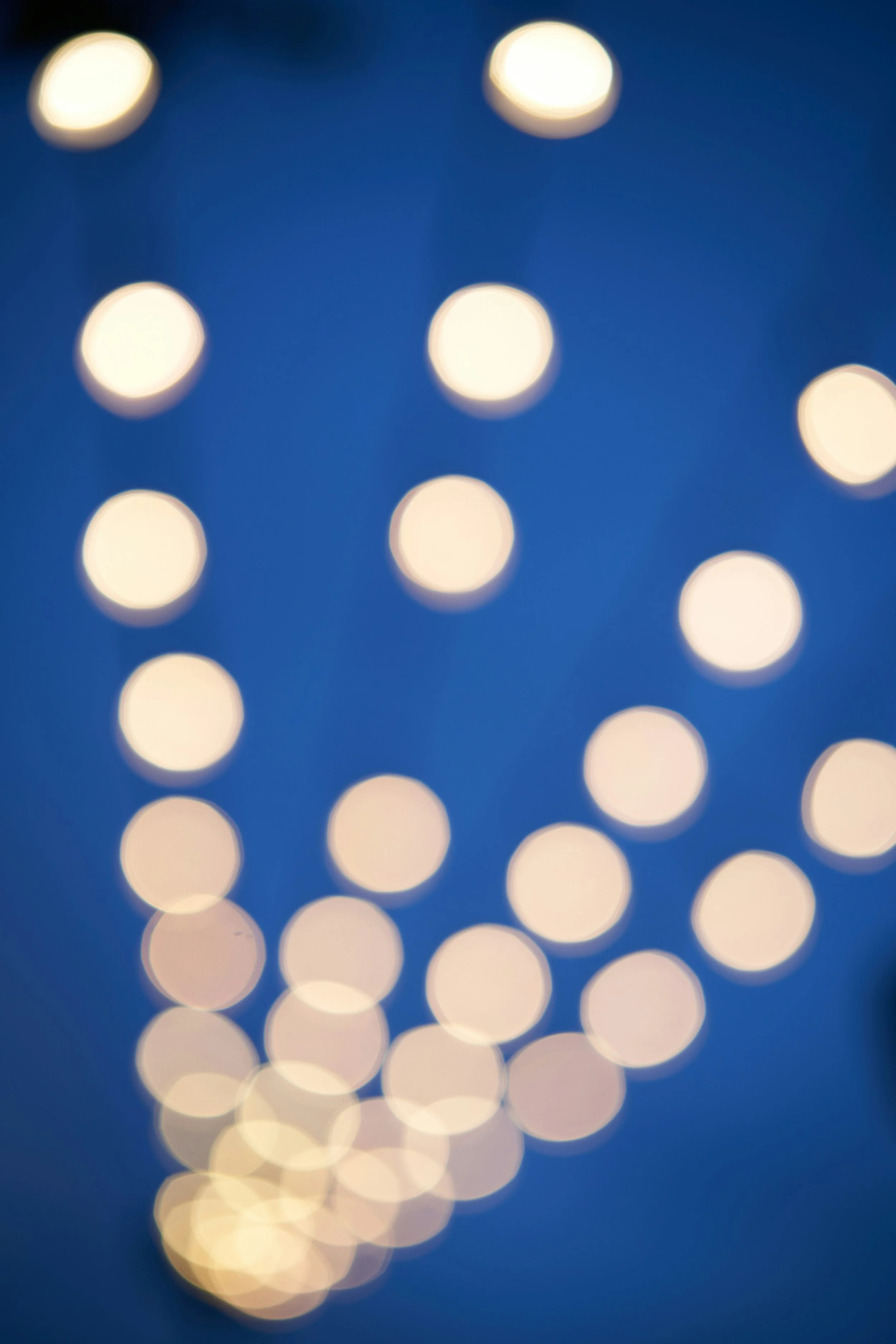 Modern wooden house with stone steps and a mountain landscape in the background.