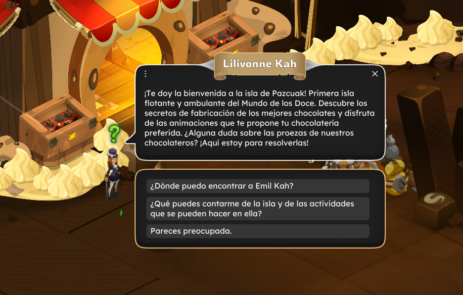 Pantalla del juego con una bienvenida a la isla de Pazcuak, mostrando cajas con chocolates y decoraciones de chocolate en un entorno de tienda o fábrica de chocolates.