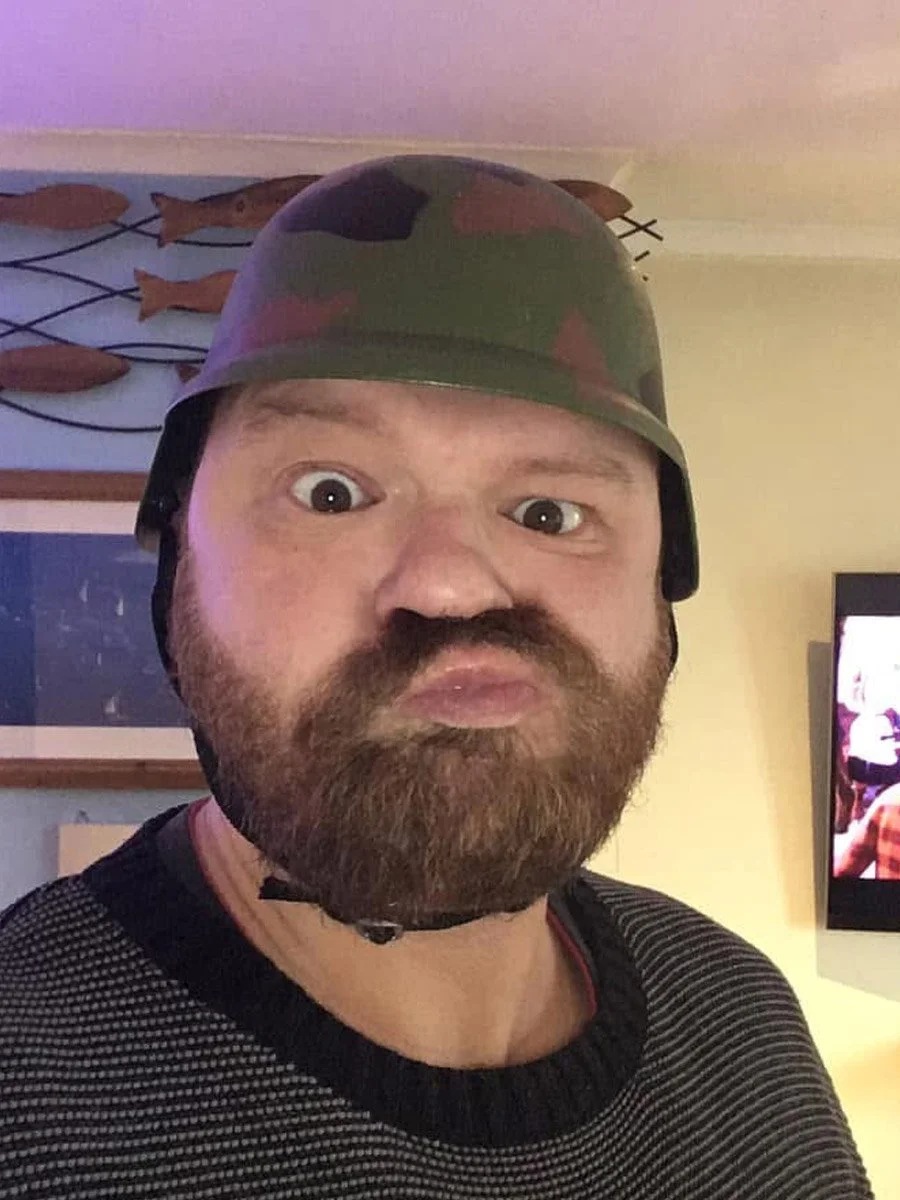 man in tin hat pulling funny face