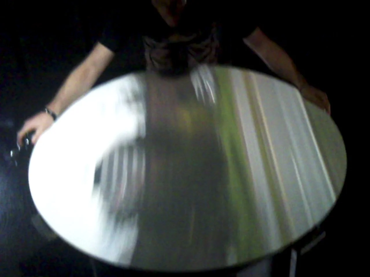 Blurry reflection on round table in dim lighting