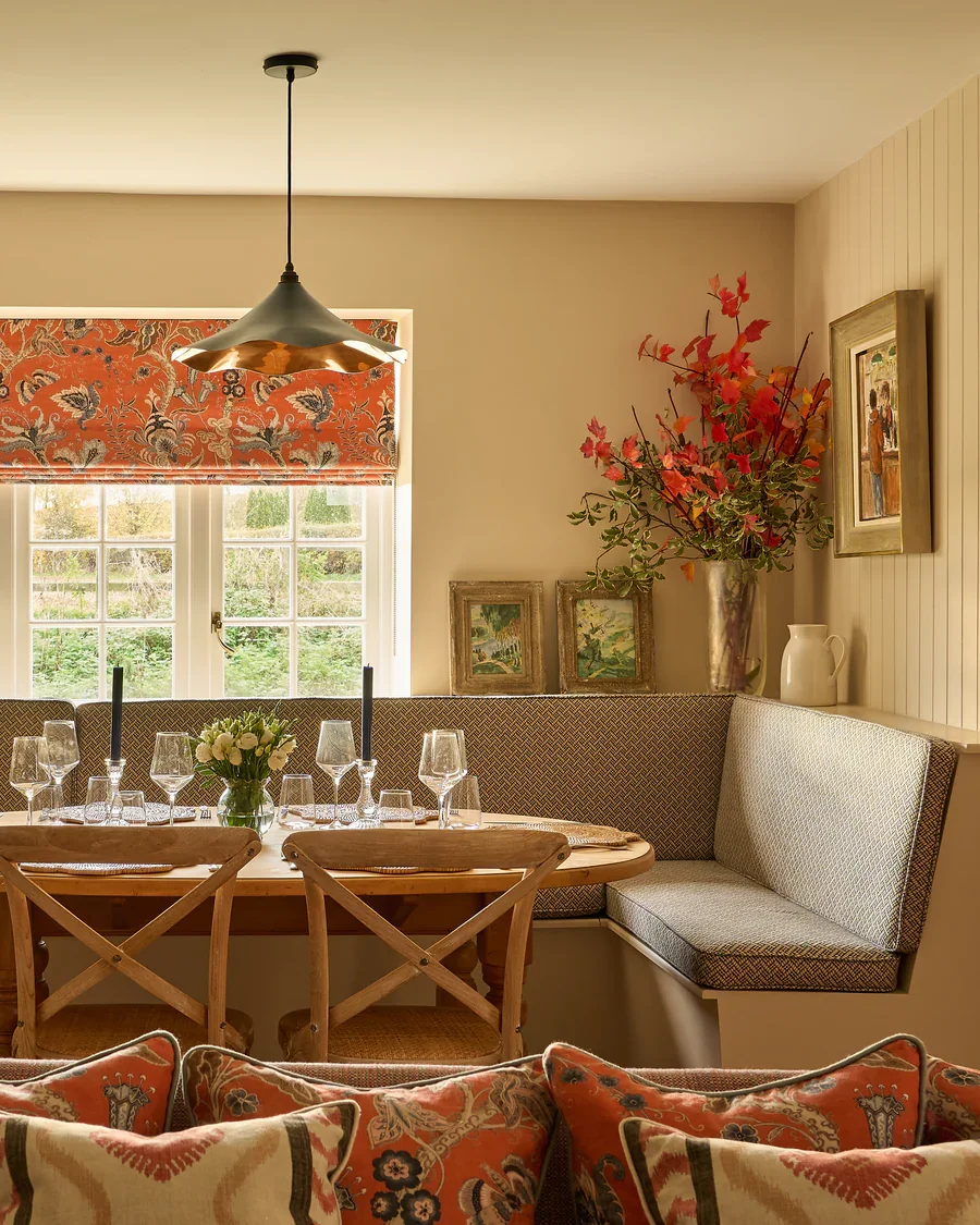Linwood fabric design Roman Blind in a window above a dining table
