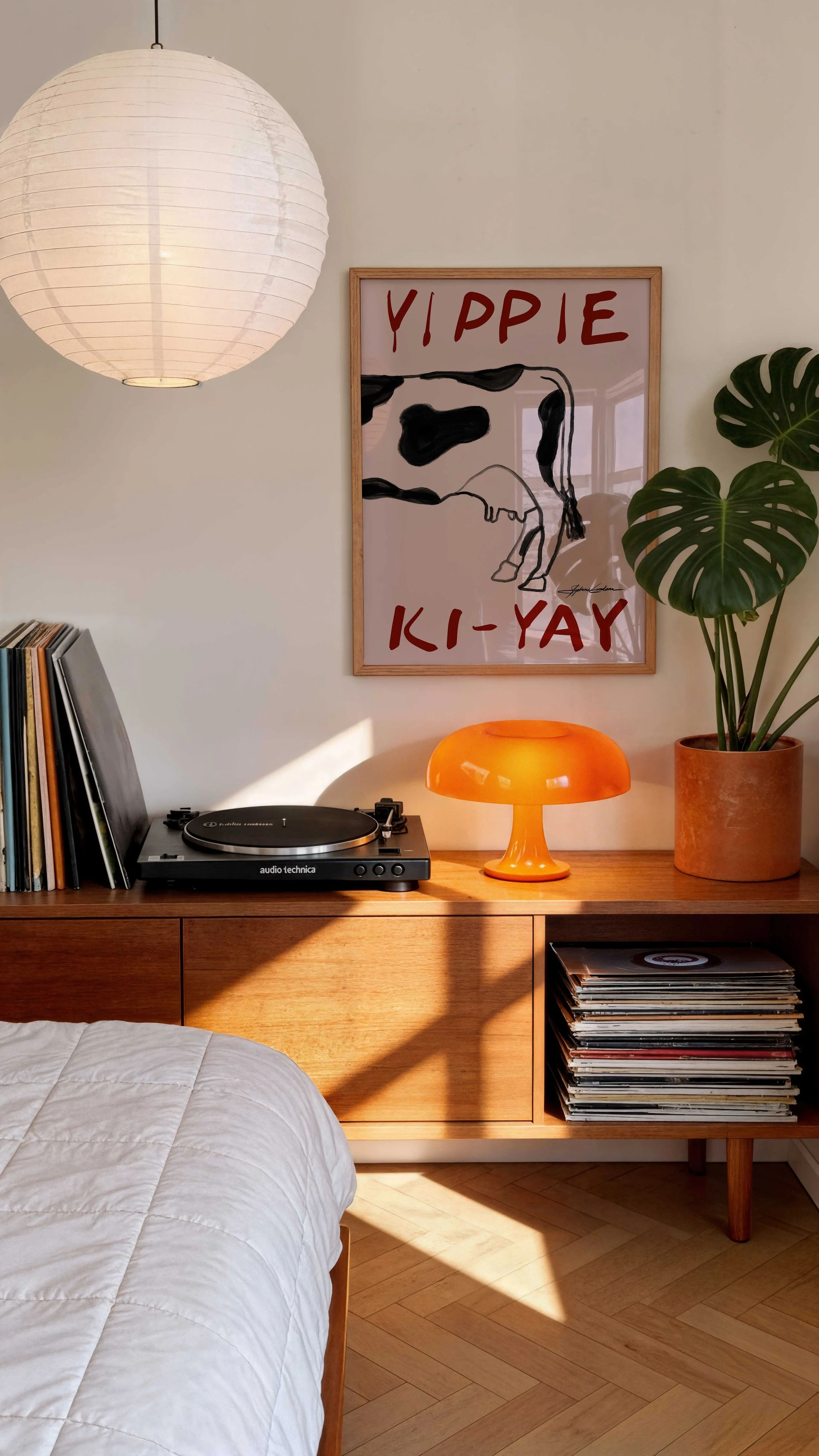 Yippie-Ki-Yay-Cow-Western-Poster--Framed-Poster-in-a-Modern-Trendy-Bedroom-with-Orange-Lamp-and-Vinyls.jpg