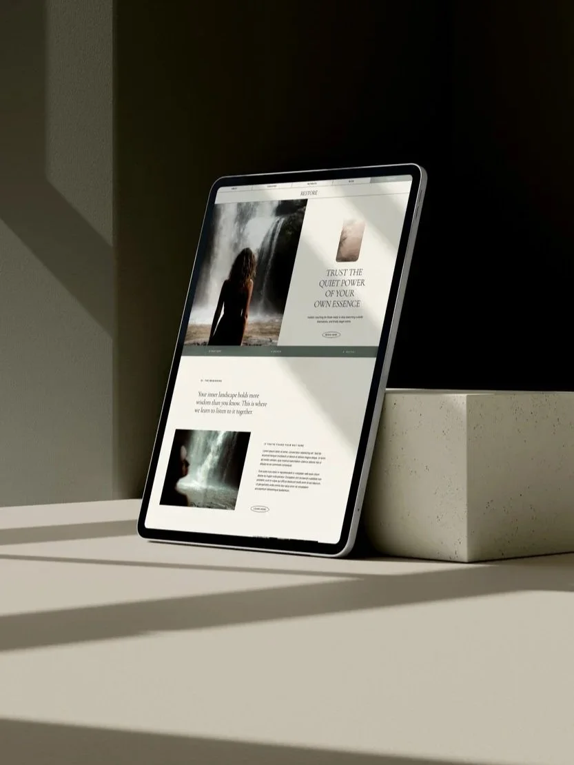 mock up of a wellness website on an ipad on a minimal desk with a shadow cutting across it