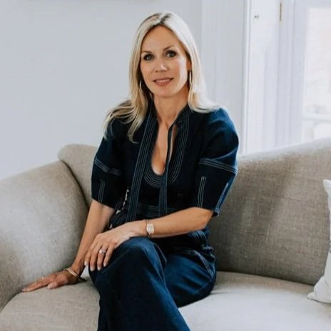 blonde lady interior designer sitting on a sofa