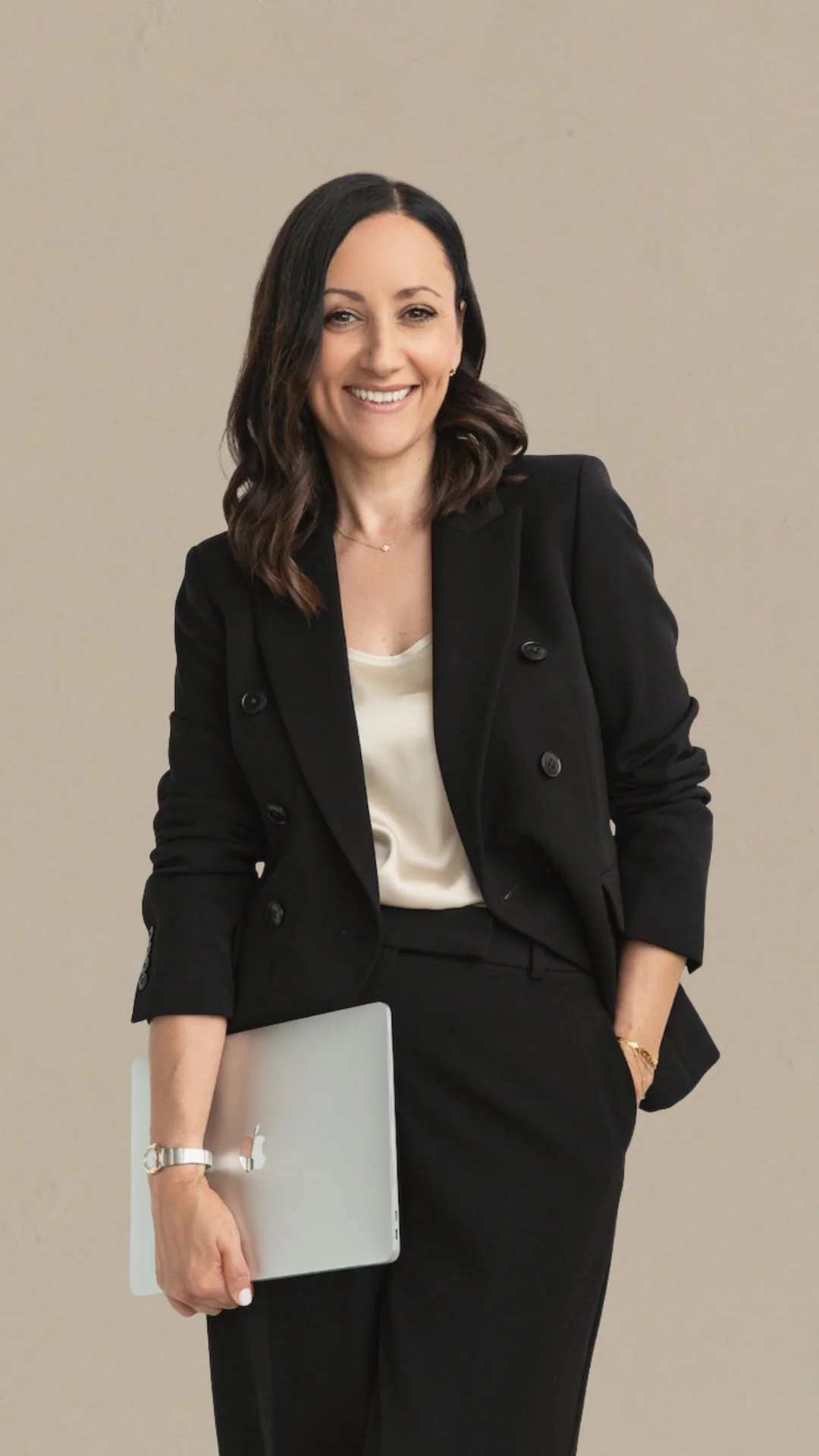 woman web designer holding a laptop underarm